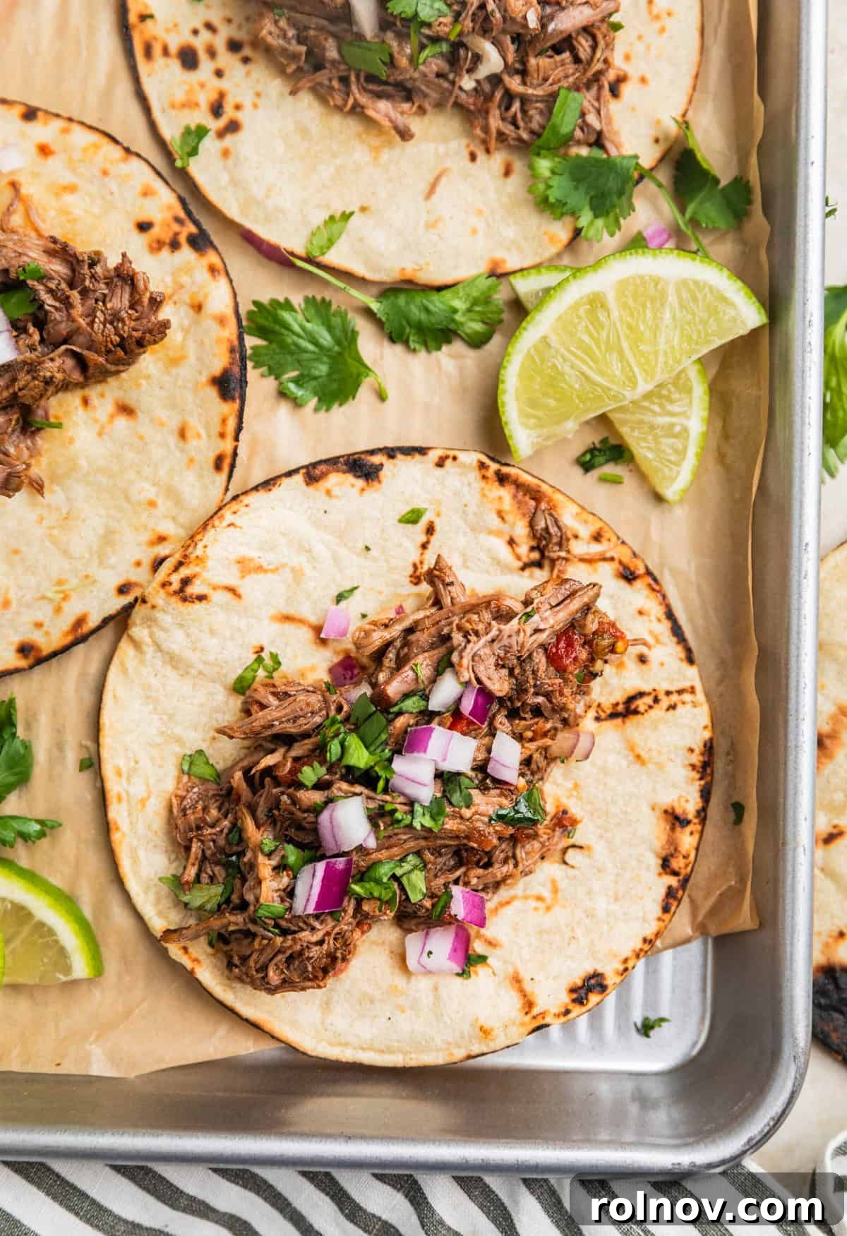 Melt In Your Mouth Slow Cooker Beef Tacos 11 Overhead view of beef tacos on tray.