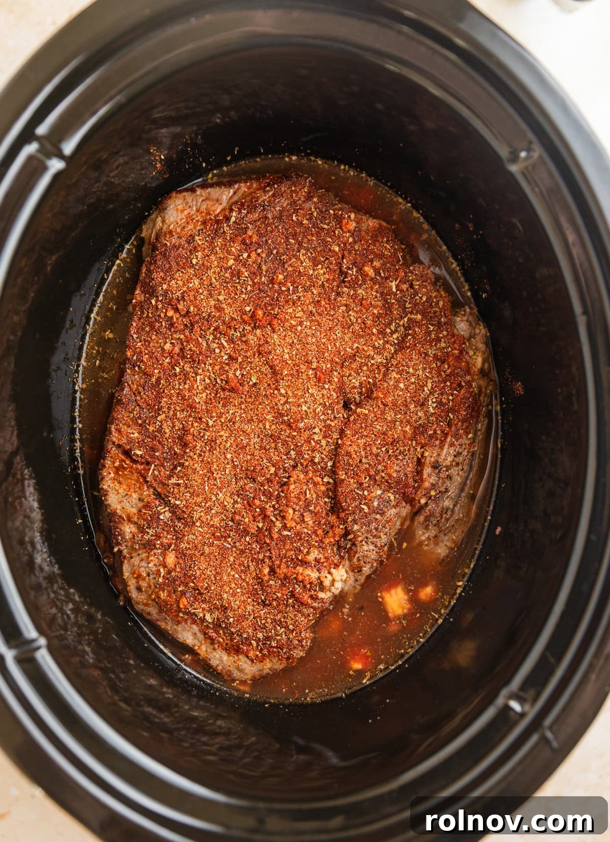 Melt In Your Mouth Slow Cooker Beef Tacos 6 Seasoned beef chuck roast in crock pot before cooking.