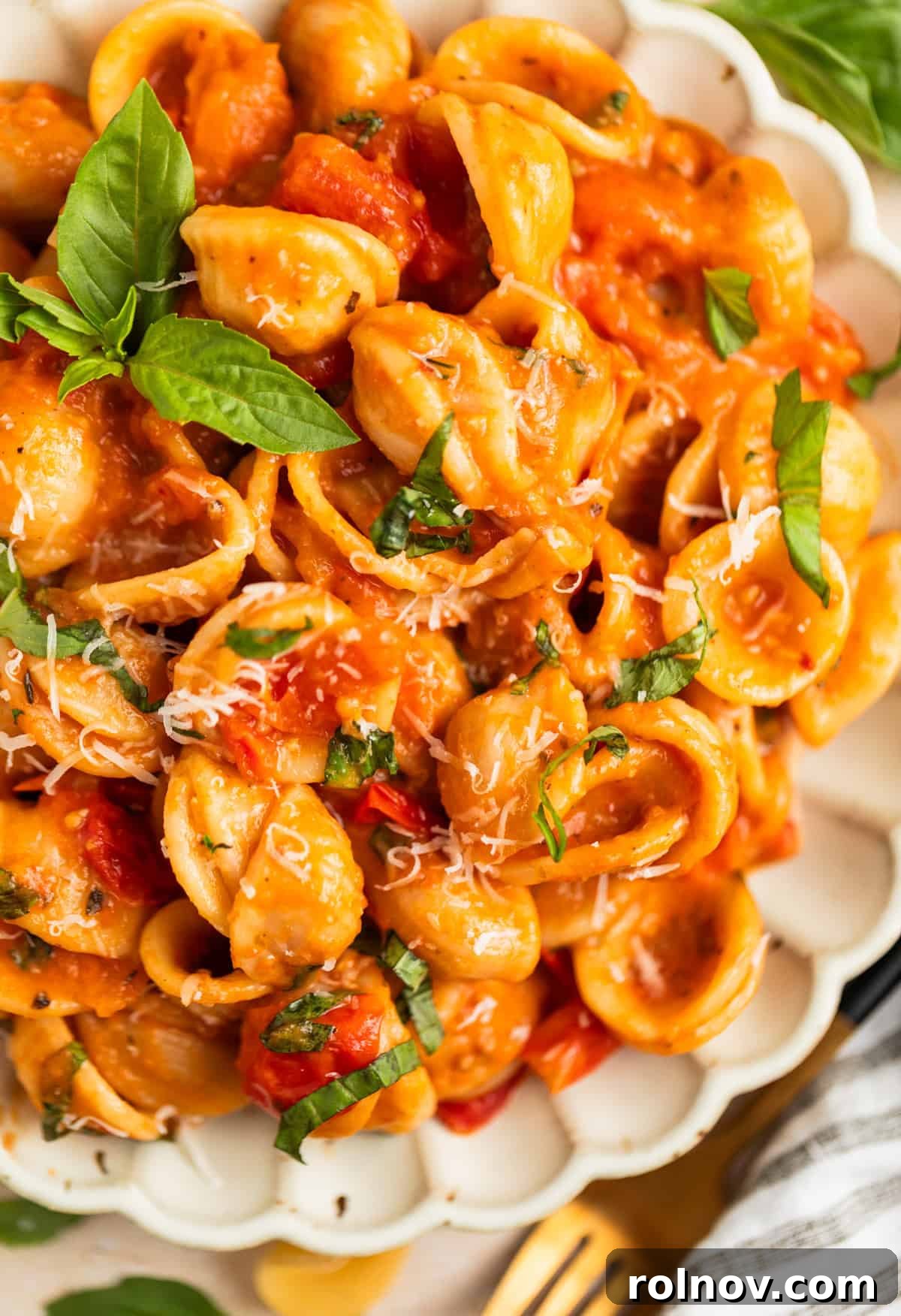 Sun-Kissed Cherry Tomato Delight 10 A beautifully plated serving of fresh cherry tomato pasta, generously topped with vibrant chopped basil and a sprinkle of grated Parmesan cheese, ready to be enjoyed.