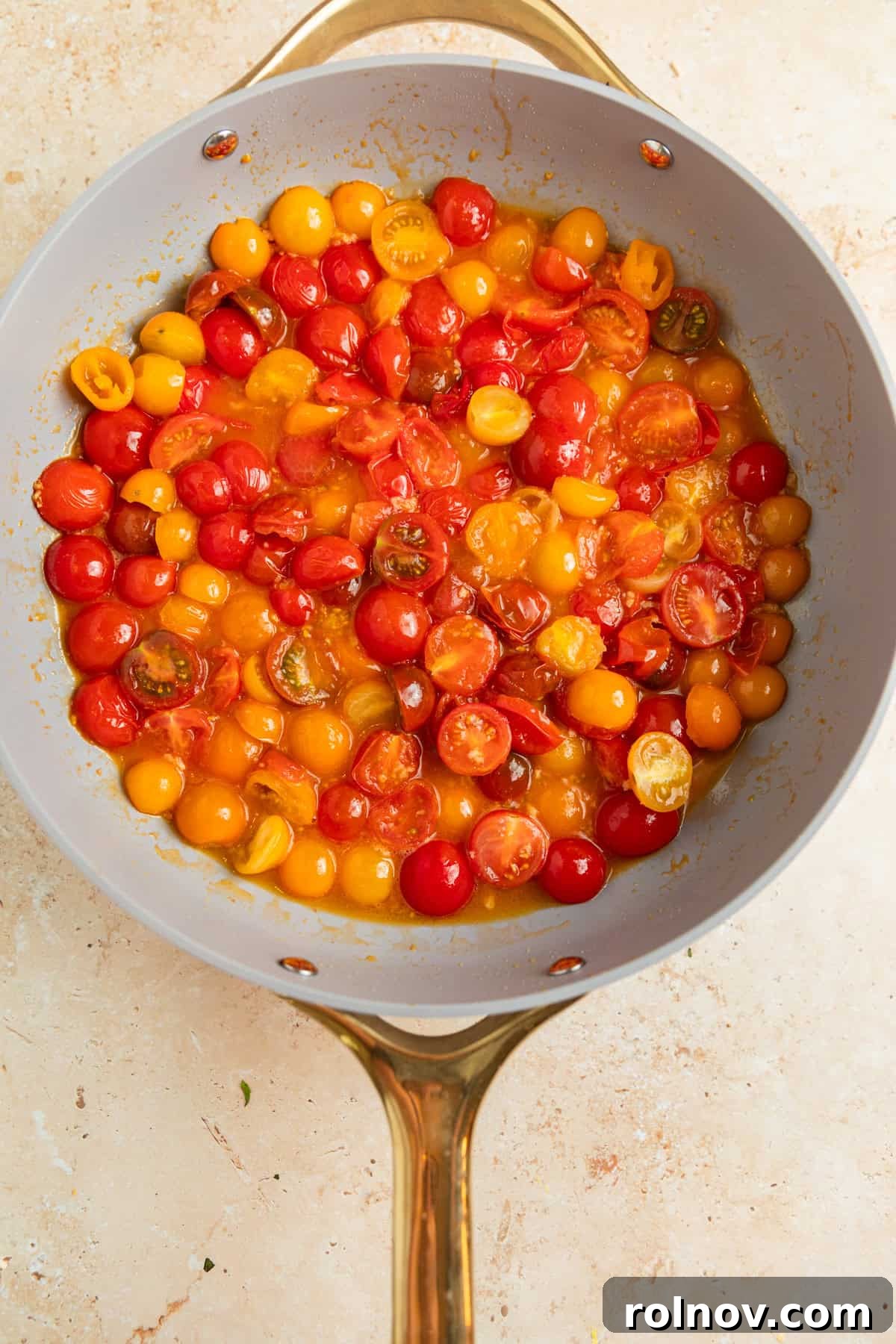 Sun-Kissed Cherry Tomato Delight 6 Cherry tomatoes vigorously simmering in the pan, actively breaking down and thickening to form a rich and flavorful sauce base.