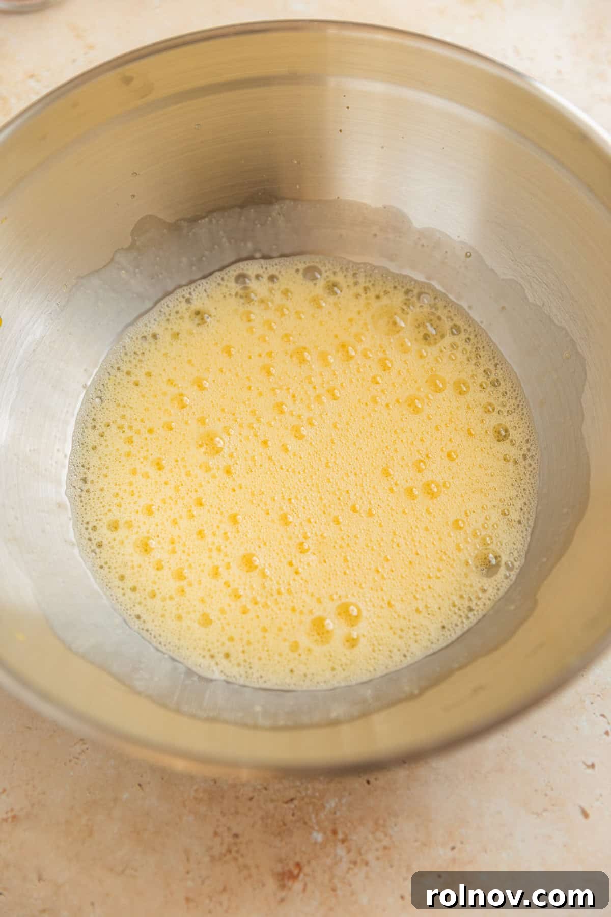 Grandmas Zucchini Bread Perfected 5 Light and frothy beaten eggs in a gleaming stainless steel mixing bowl.