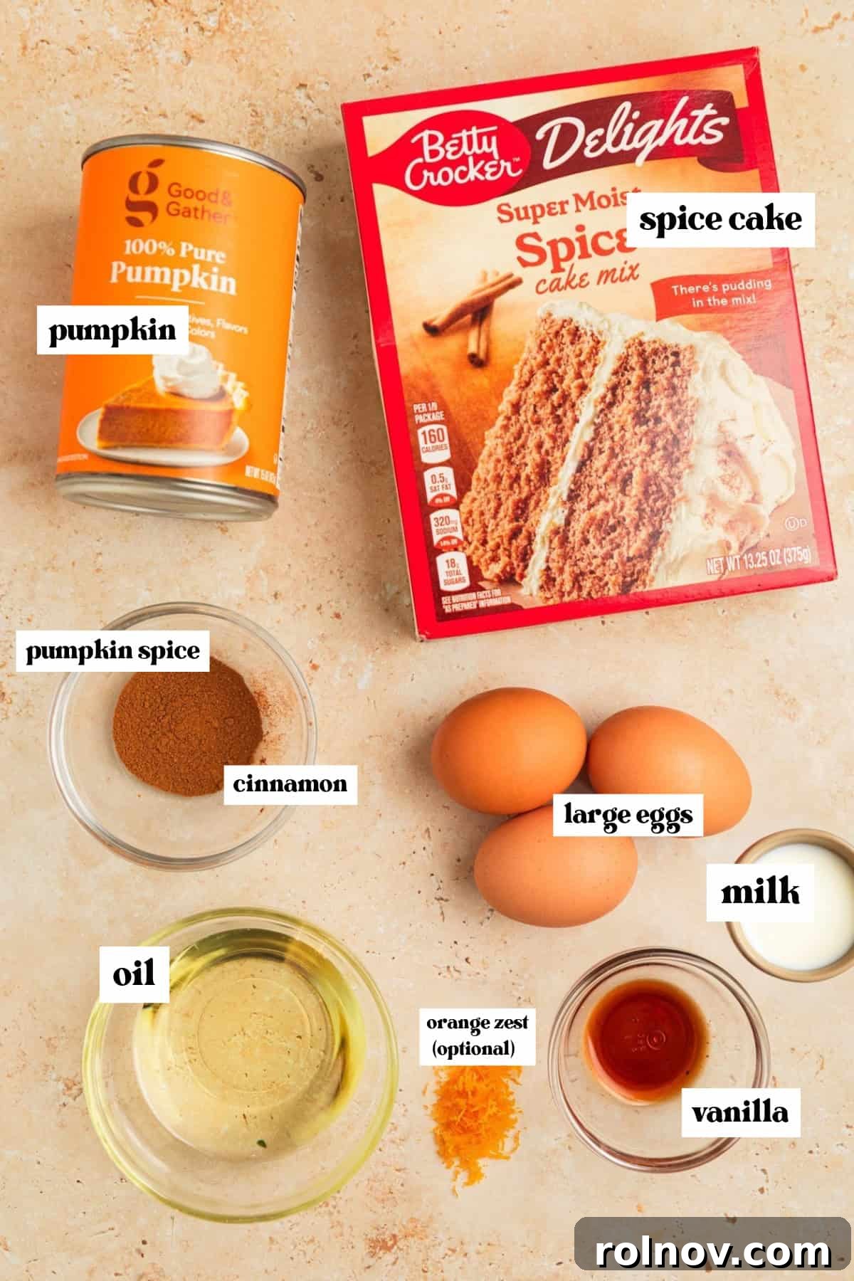 Effortless Cake Mix Pumpkin Bread 4 A collection of key ingredients for the recipe, including a can of pumpkin purée, a spice cake mix box, cooking oil, and eggs, arranged neatly for preparation.