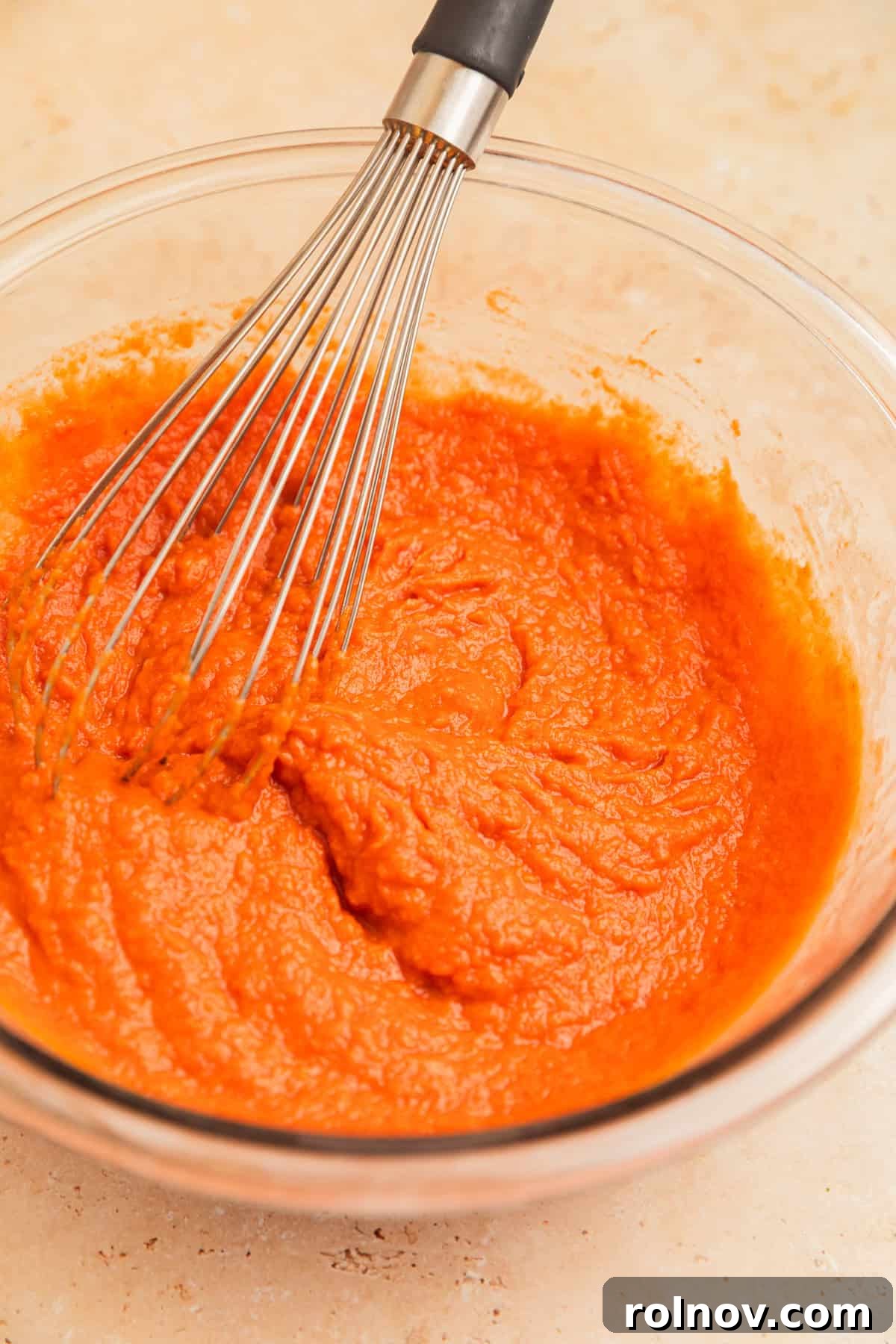Effortless Cake Mix Pumpkin Bread 7 The pumpkin mixture in a glass bowl, thoroughly whisked and ready for dry ingredients.