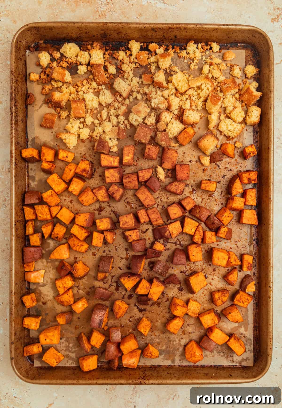 Roasted Sweet Potato Kale Salad 7 A sheet pan showcasing perfectly roasted sweet potatoes alongside golden brown cornbread croutons, fresh out of the oven.