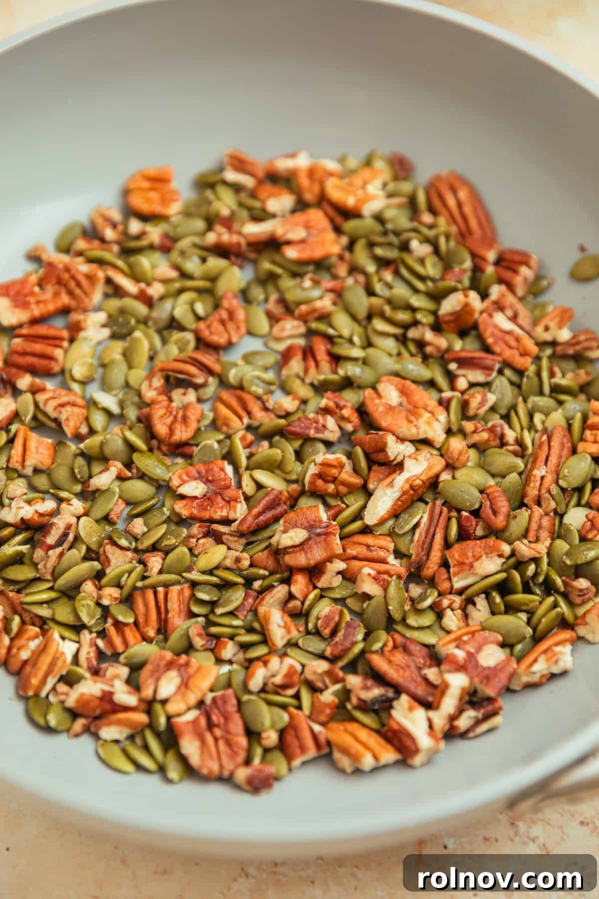 Roasted Sweet Potato Kale Salad 8 Toasted pecans and pepitas gently browning in a skillet on the stovetop, releasing their fragrant aroma.