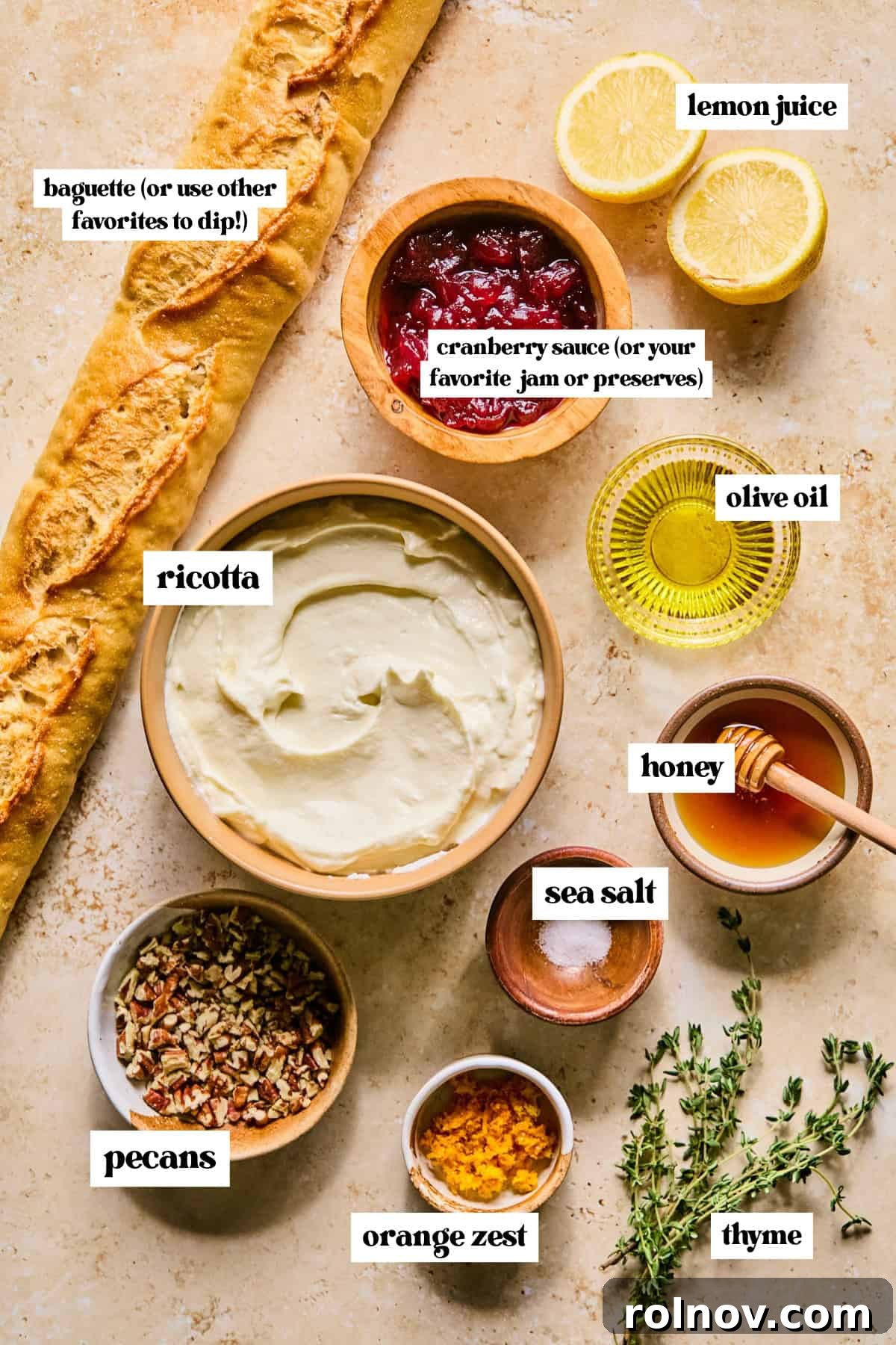 Arrangement of fresh baguette, whole milk ricotta, golden honey, and vibrant cranberry sauce, essential ingredients for the dip.