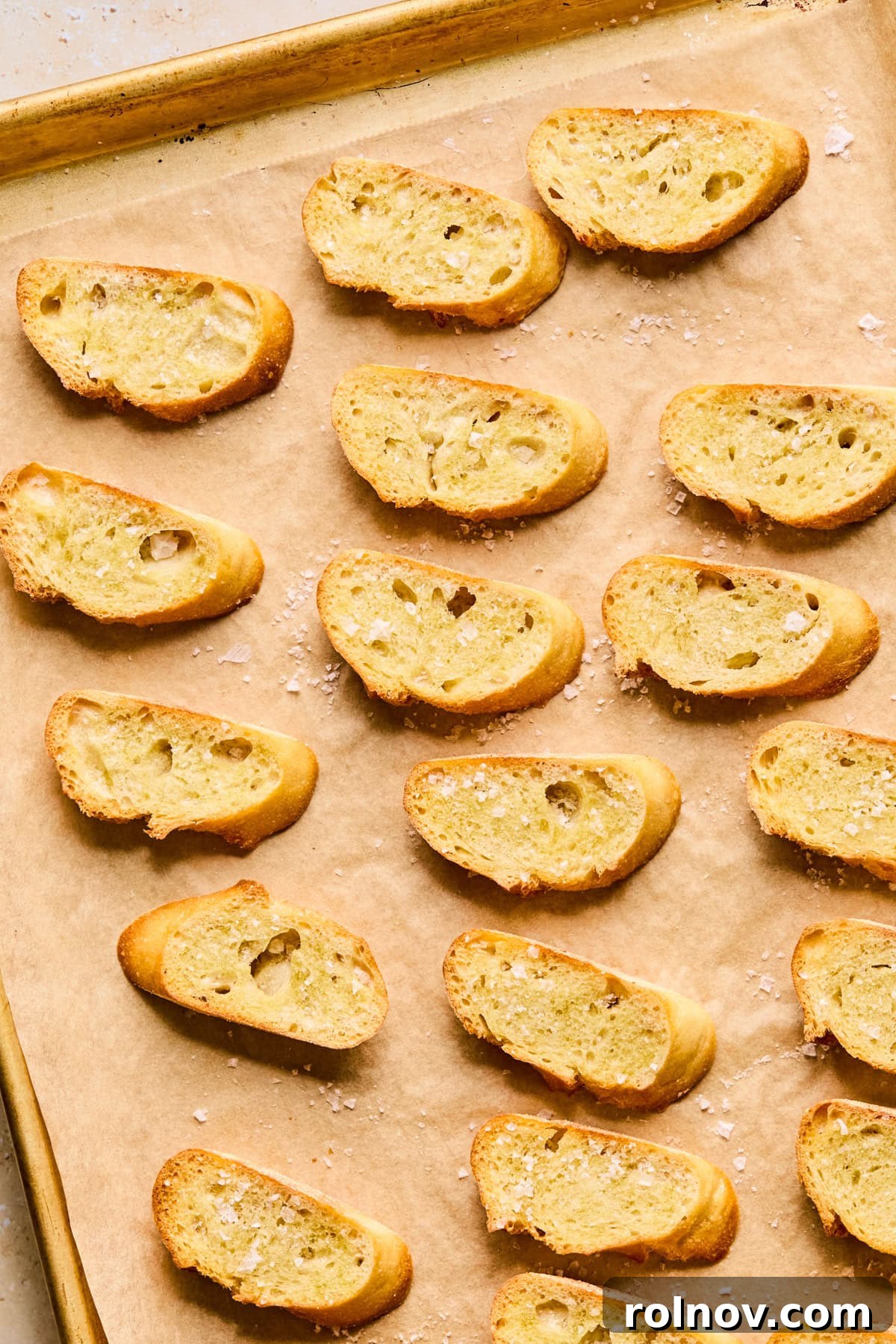 Perfectly toasted crostini slices, golden brown and lightly salted, ready to serve with the dip.