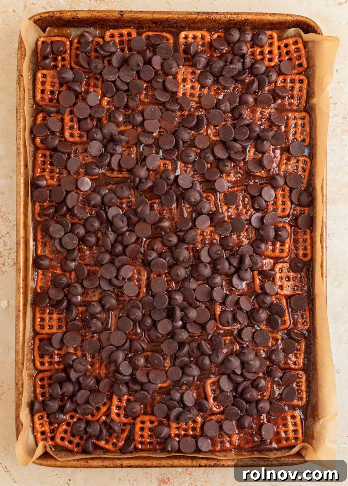 Salty Sweet Pretzel Toffee Crunch 10 Dark chocolate chips generously sprinkled over the hot pretzel toffee immediately after being removed from the oven, ready to melt.