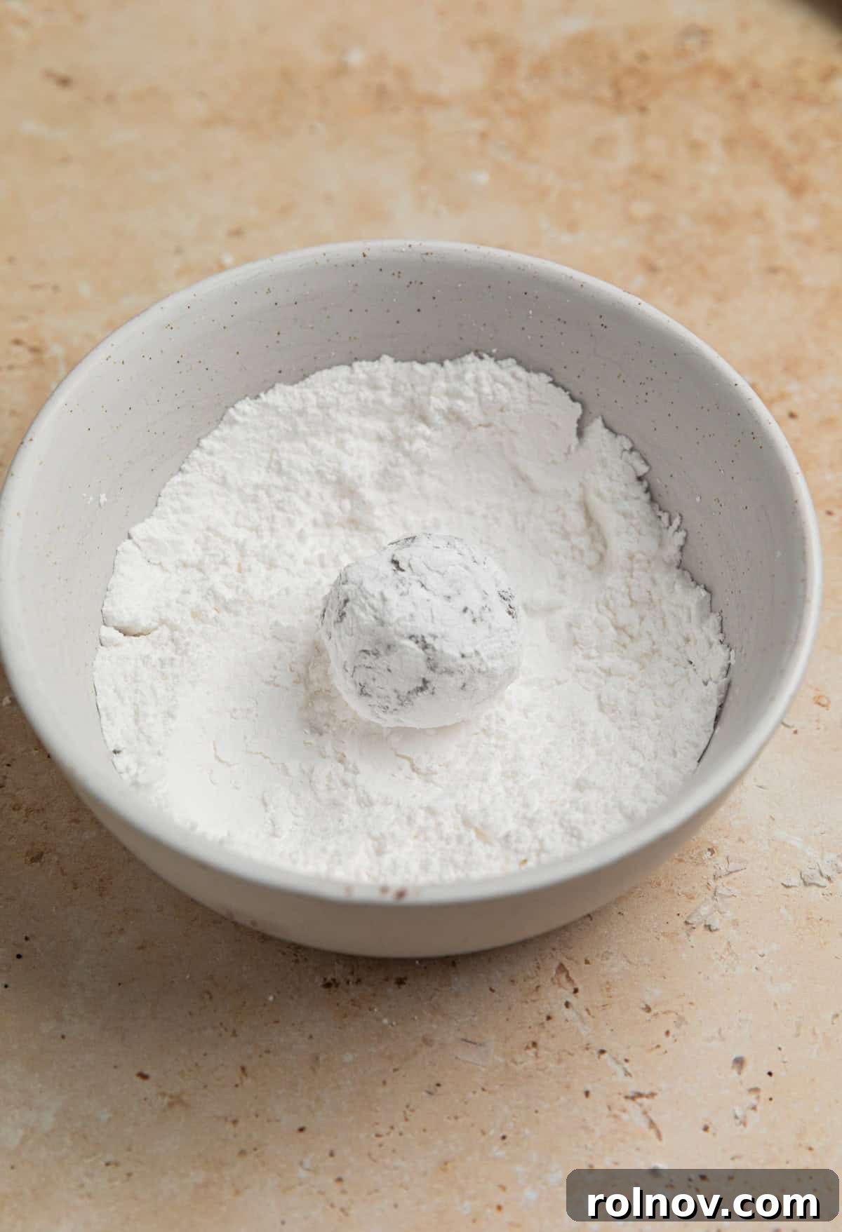 Velvet Chocolate Crinkle Blossoms 6 Cookie dough ball rolled into powdered sugar.