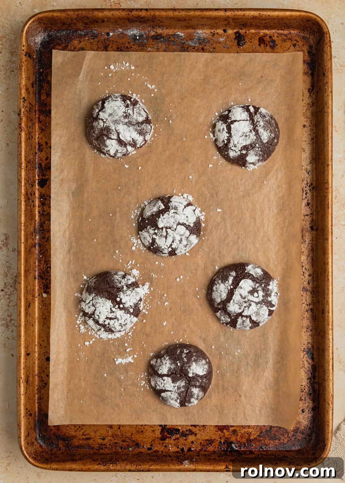 Velvet Chocolate Crinkle Blossoms 8 Chocolate crinkle cookies fresh from oven on cookie sheet.