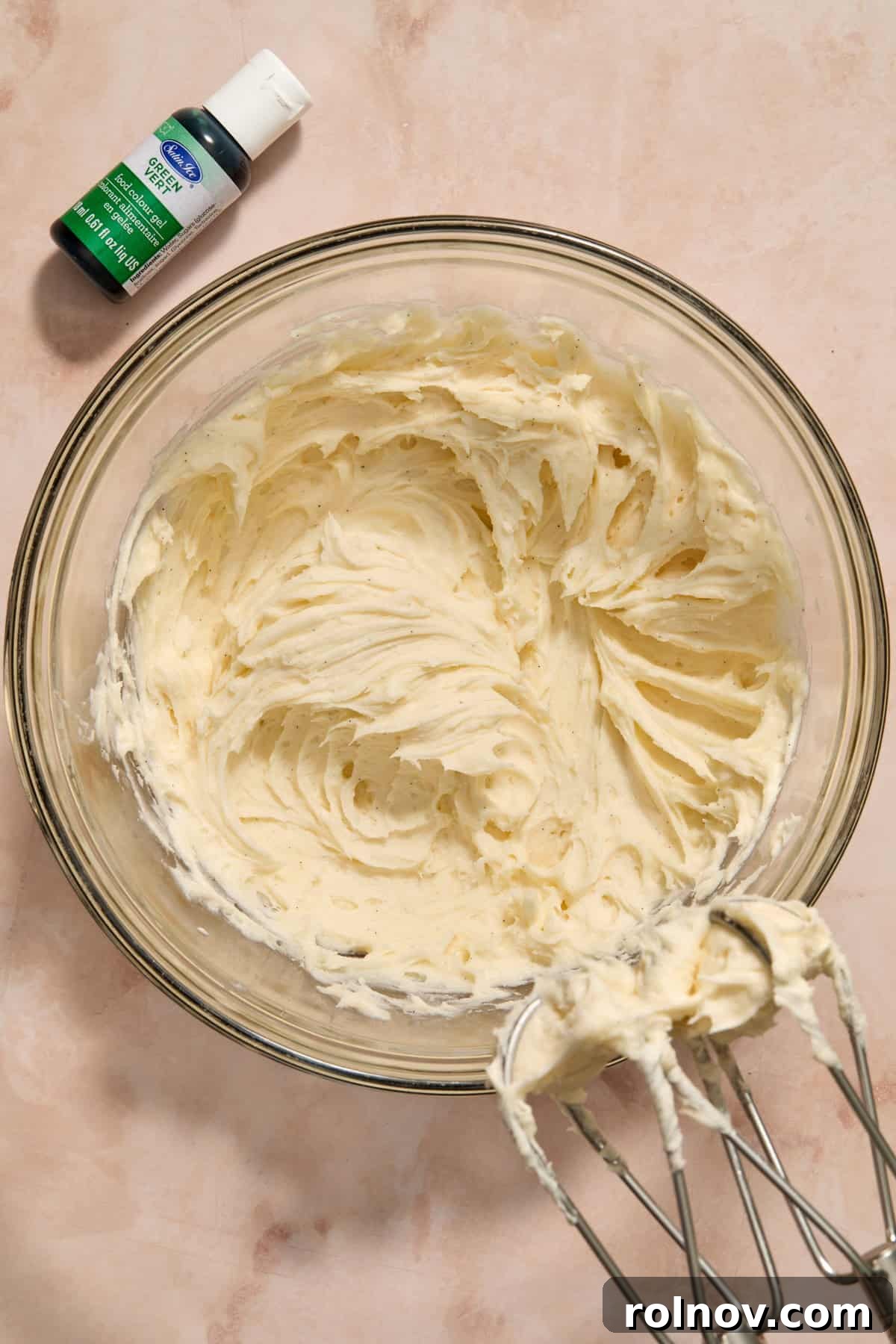 Smooth and creamy buttercream frosting whipped in a mixing bowl.