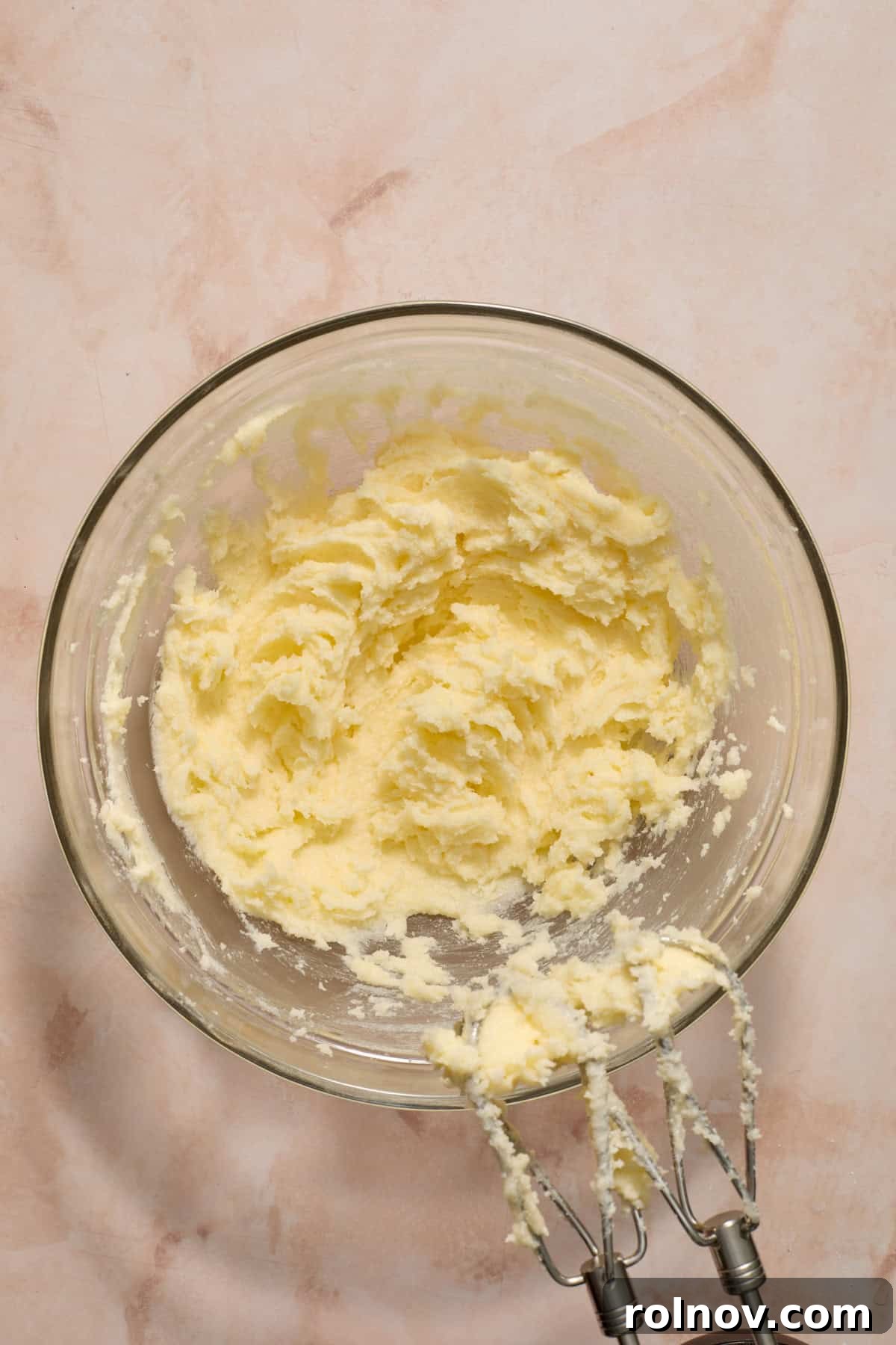 Butter and sugar creamed together in a mixing bowl.
