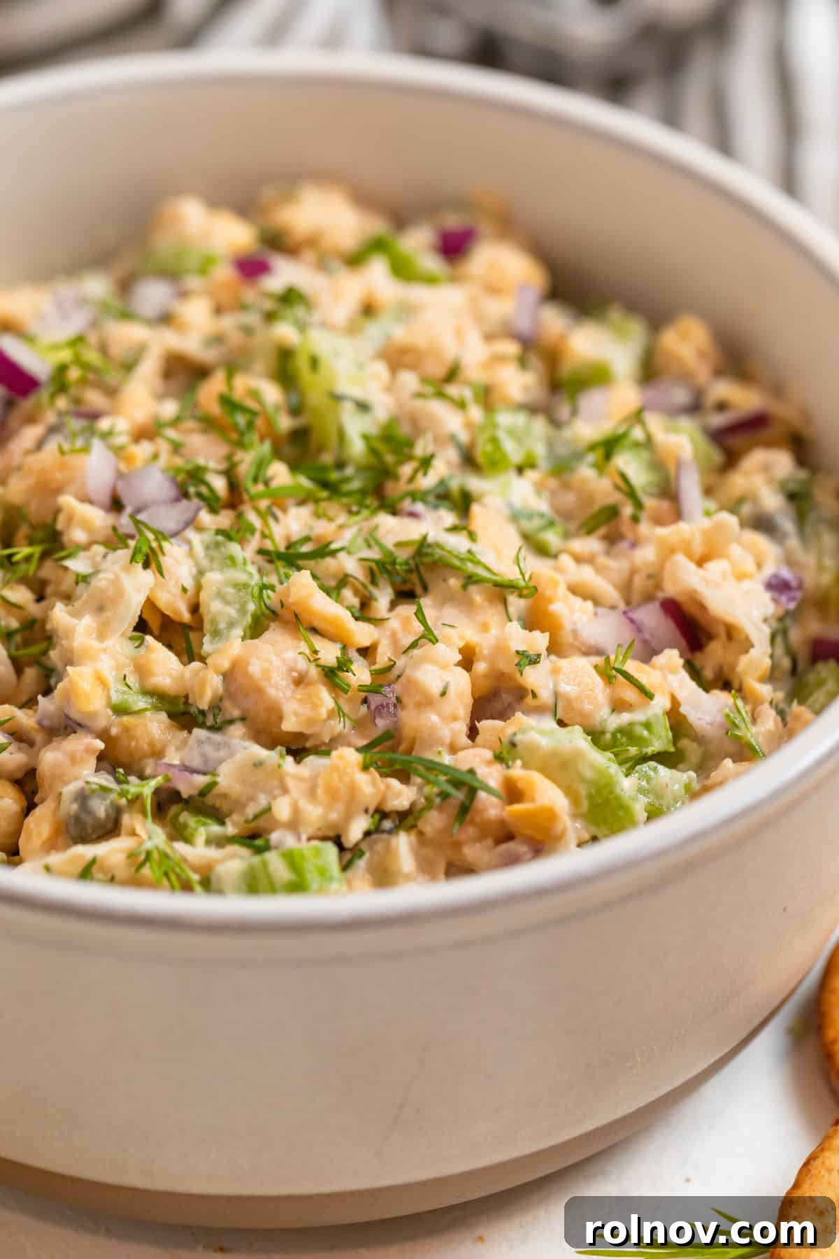 Plant-Based Chickpea Tuna Salad 2 Vegan chickpea tuna salad in a clay bowl topped with freshly chopped dill.