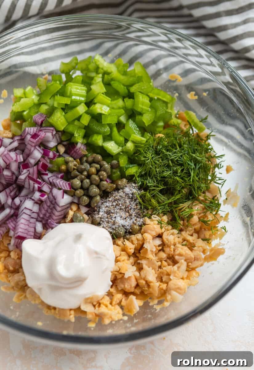 Plant-Based Chickpea Tuna Salad 6 All vegan chickpea tuna salad recipe ingredients in a mixing bowl before being stirred together.