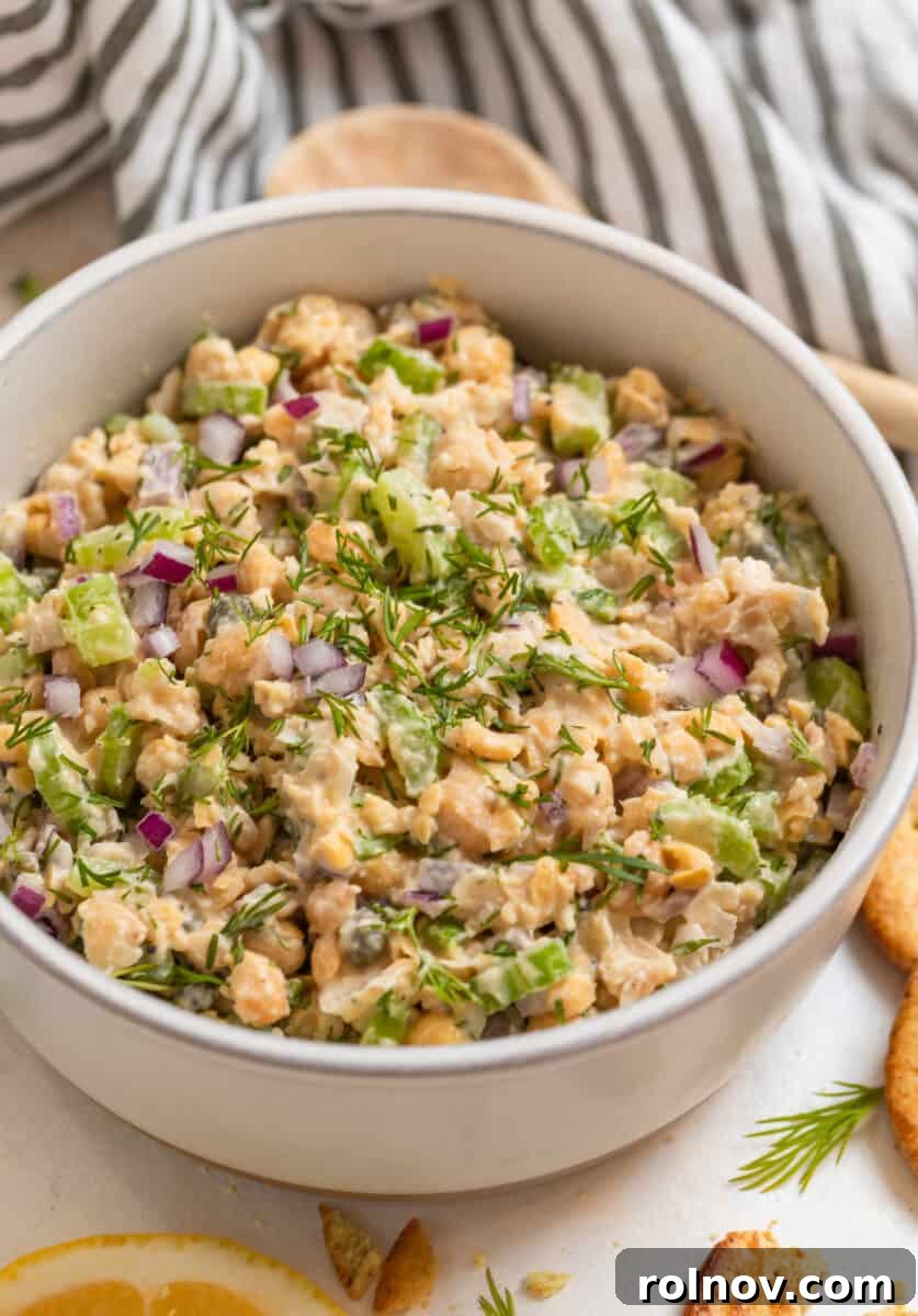 Plant-Based Chickpea Tuna Salad 8 Vegan chickpea mock tuna salad in a serving bowl, garnished with fresh dill sprigs.