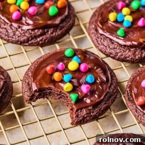 Supernova Brownie Cookies 16 Cosmic brownie cookies on wire rack with bite taken out.