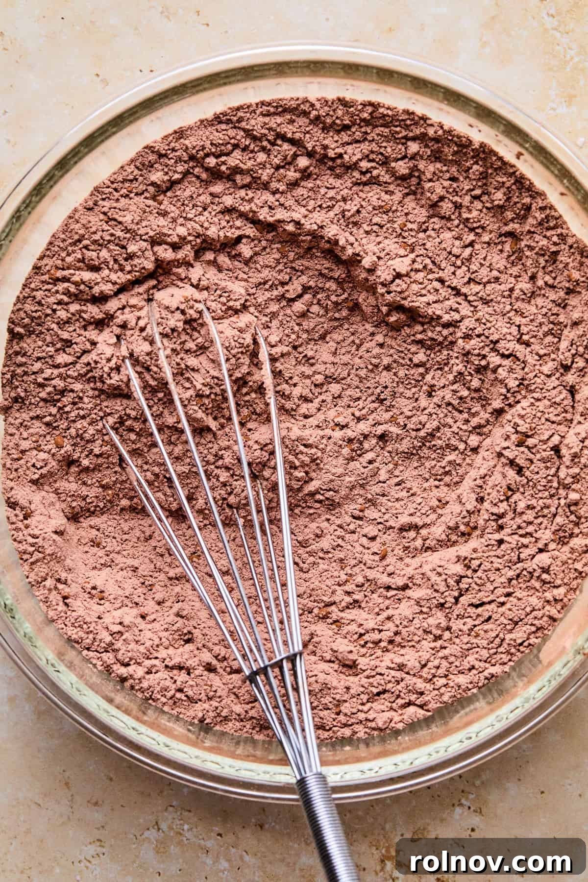 Supernova Brownie Cookies 5 Mixing bowl with whisk and dry ingredients, including flour and cocoa powder, combined.