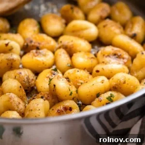 Pan fried gnocchi tossed in butter and parmesan, topped with chopped parsley.