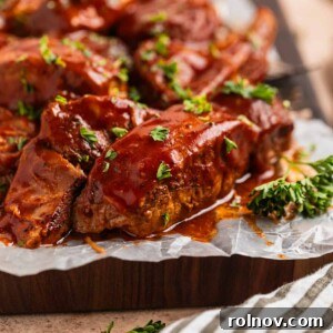 BBQ boneless pork ribs on a cutting board, garnished with chopped fresh parsley.