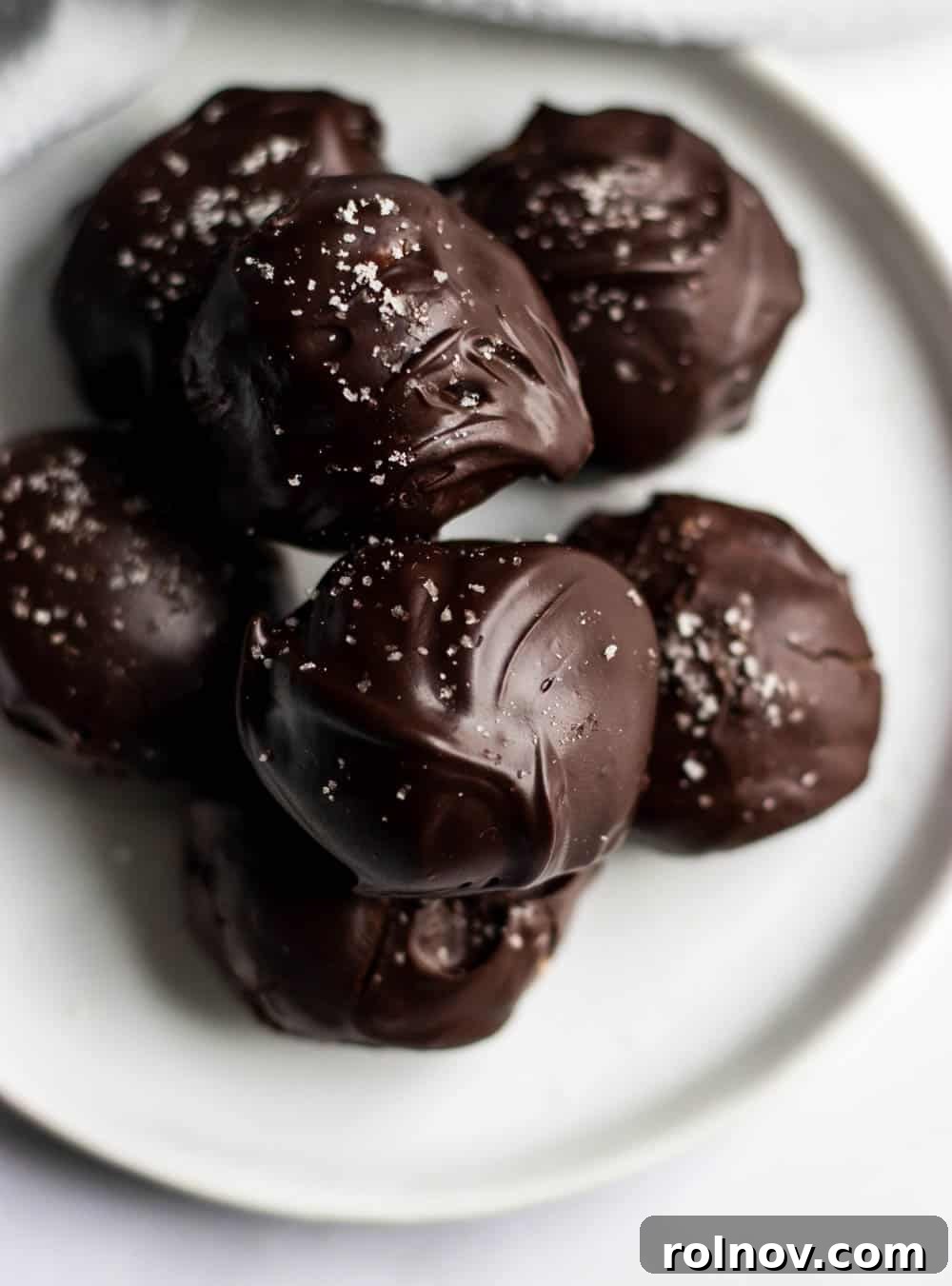 Decadent Homemade Peanut Butter Cup Truffles 4 A close-up of a single peanut butter cup truffle, showcasing the smooth dark chocolate shell and the soft, rich peanut butter interior.