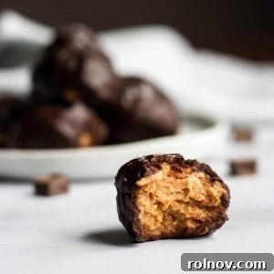 Decadent Homemade Peanut Butter Cup Truffles 5 A perfectly shaped round peanut butter cup truffle, coated in dark chocolate and ready to eat.