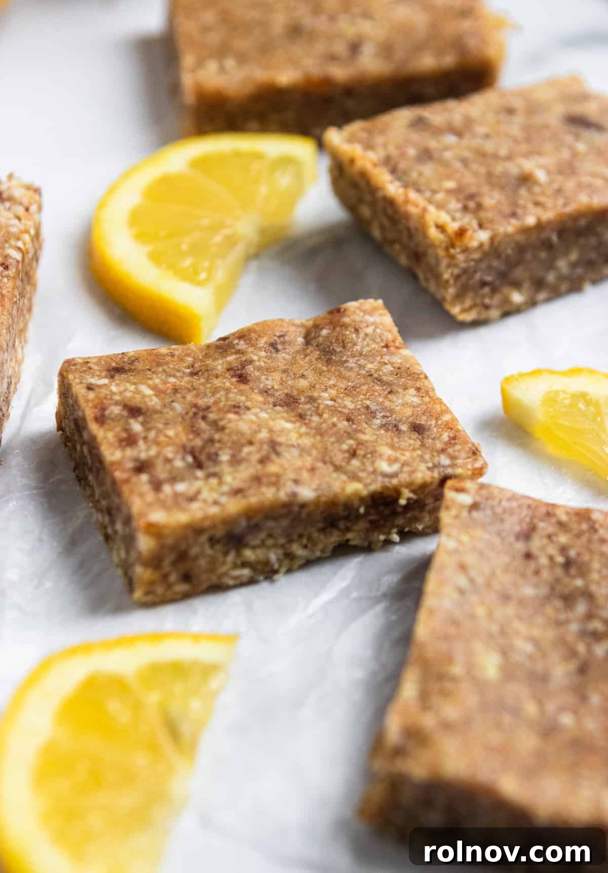 Tropical No-Bake Lemon Coconut Delights 7 Energy Bar with fresh lemons.