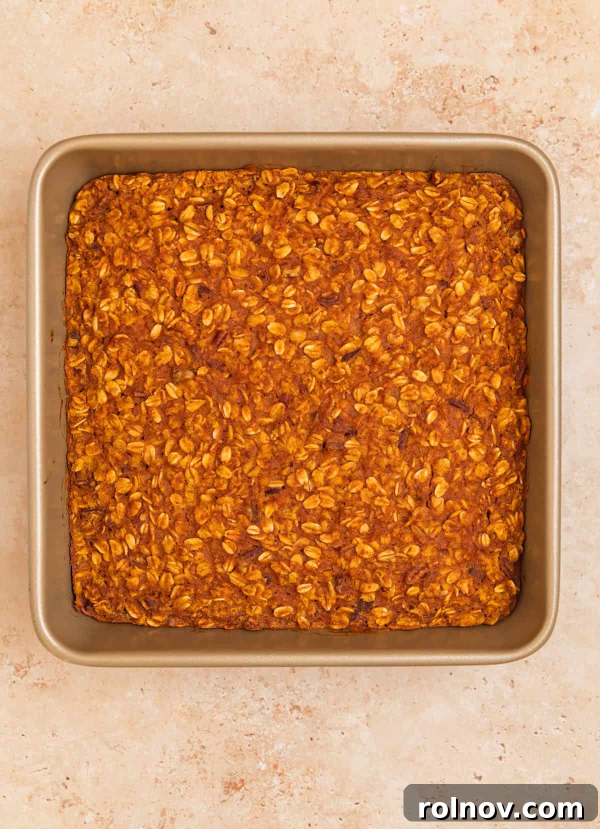 Spiced Pumpkin Oatmeal Bake 10 A baked pumpkin oatmeal in its pan, showcasing a golden-brown top, indicating it's perfectly cooked and ready to be enjoyed.