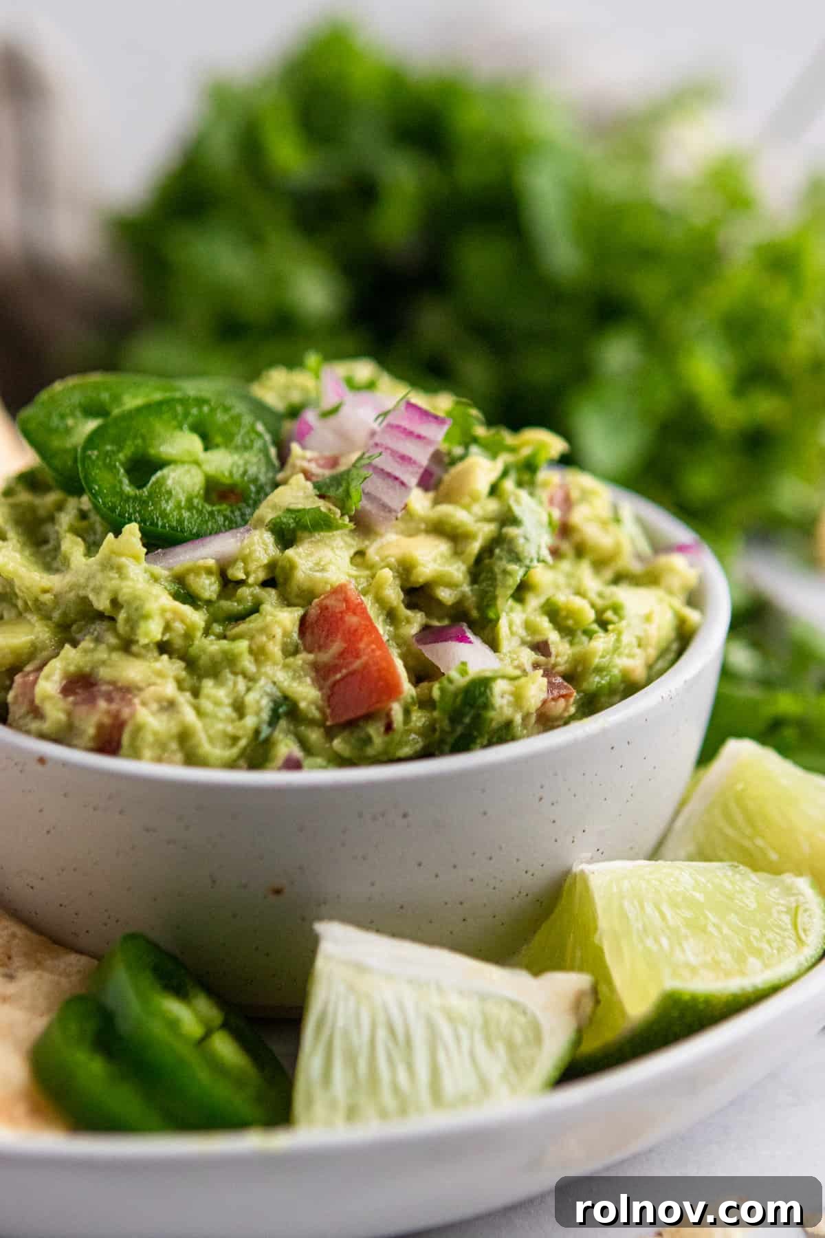 Wholesome Guacamole Made Easy 3 Healthy guacamole recipe on plate with limes.