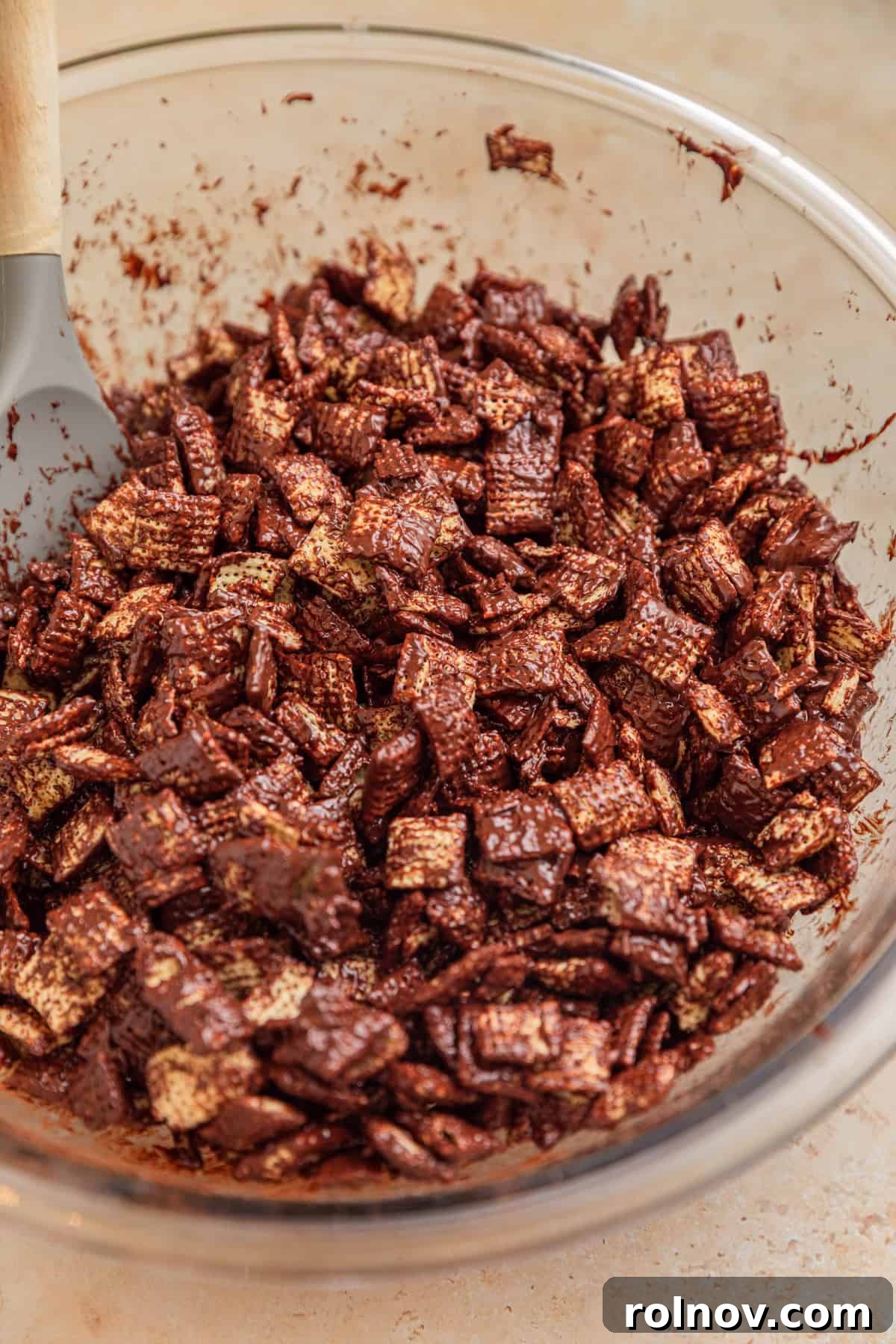 Reindeer Chow Delight 6 A bowl of dark chocolate-coated Chex cereal, perfectly prepared for the next step.