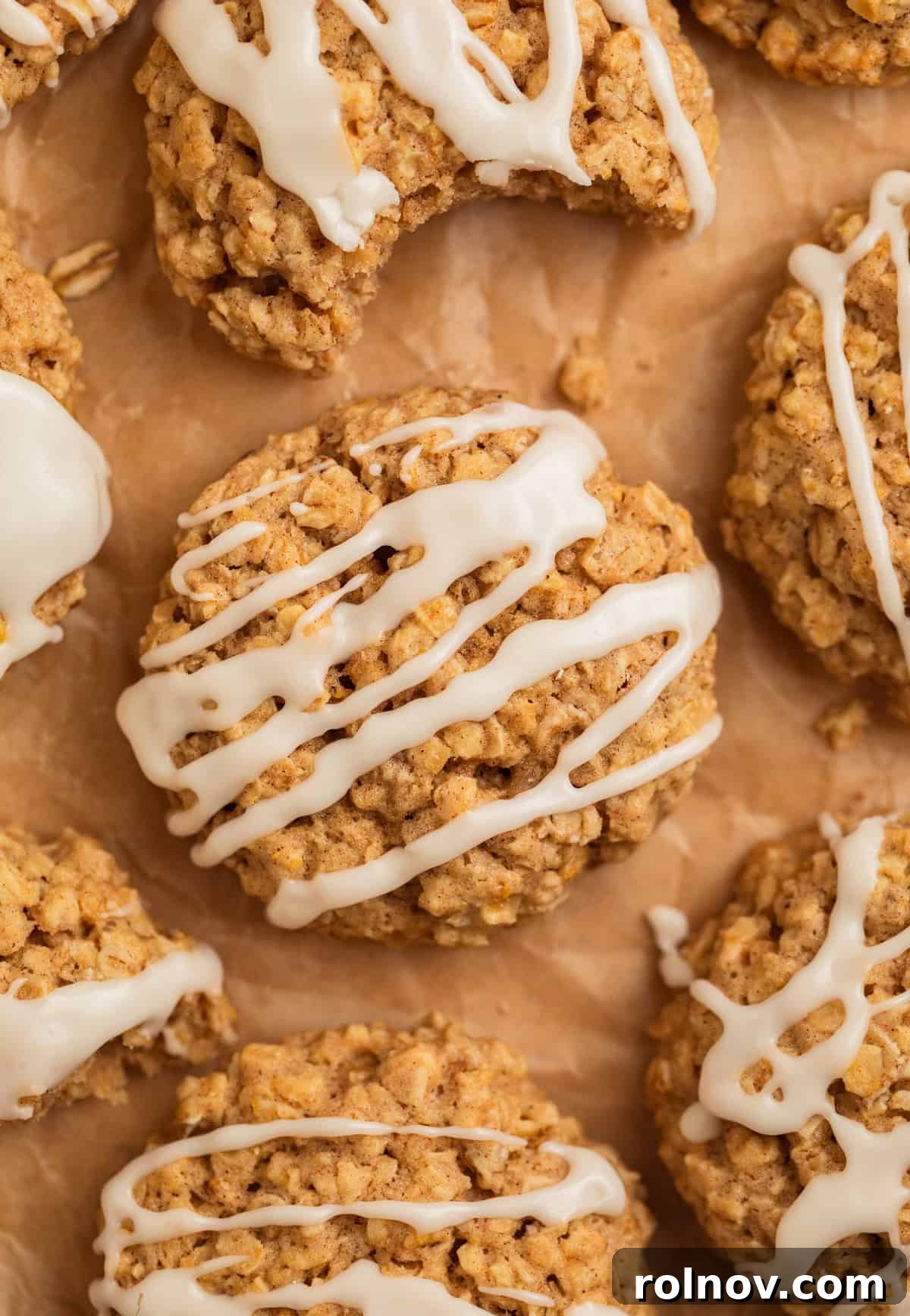 Morning Cinnamon Swirl Cookies 2 Delicious cinnamon oatmeal breakfast cookies with sweet icing drizzle arranged on parchment paper, ready to be enjoyed.
