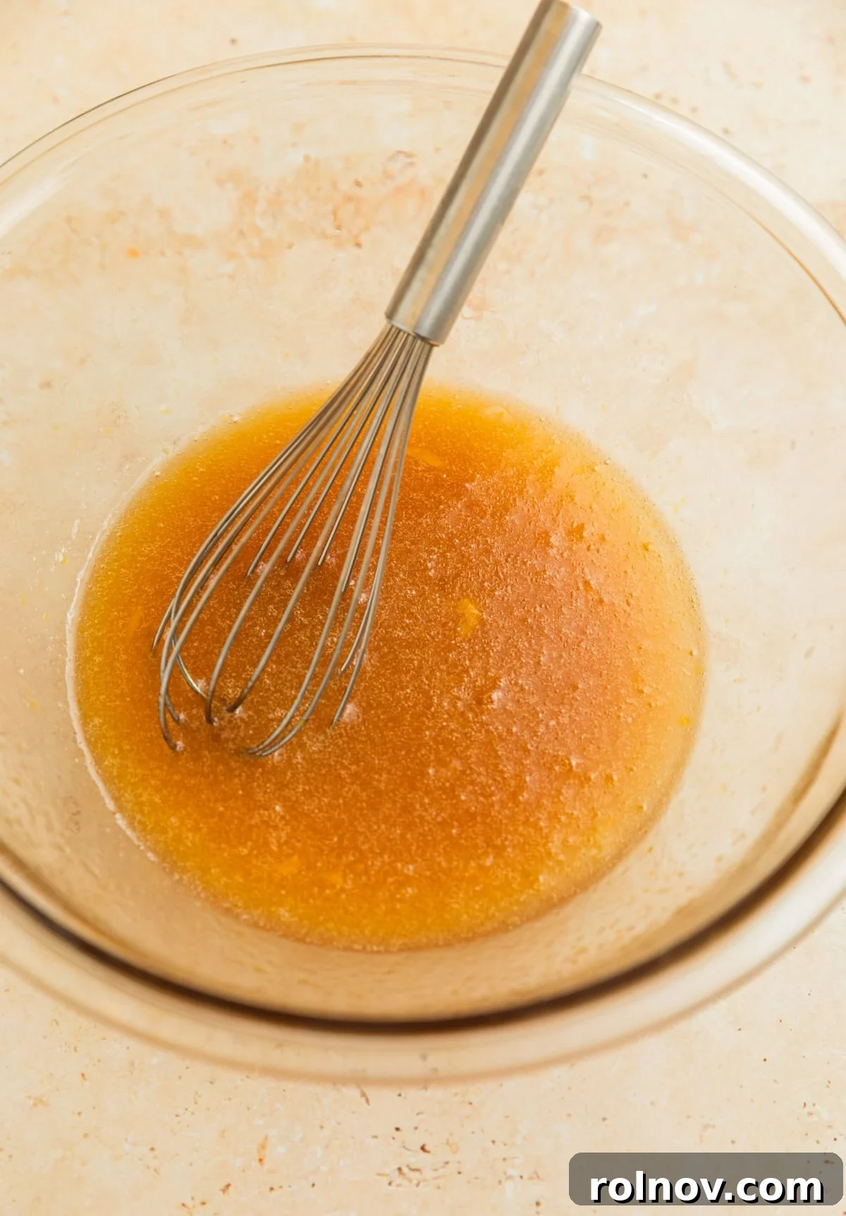 Morning Cinnamon Swirl Cookies 5 Melted butter, egg, oil, and maple syrup being whisked together in a clear glass bowl.