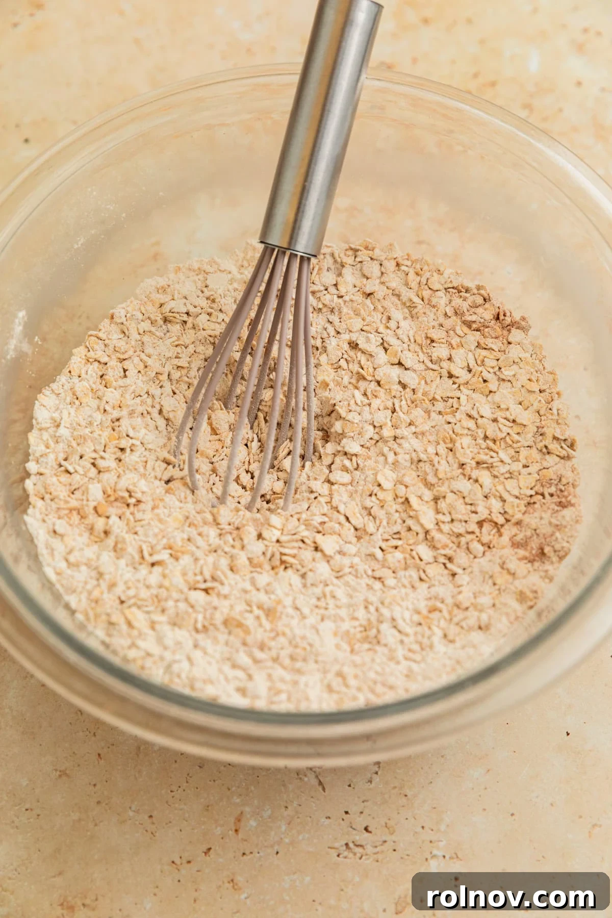 Morning Cinnamon Swirl Cookies 7 A whisk blending the dry ingredients: oats, flour, and spices, in a bowl.