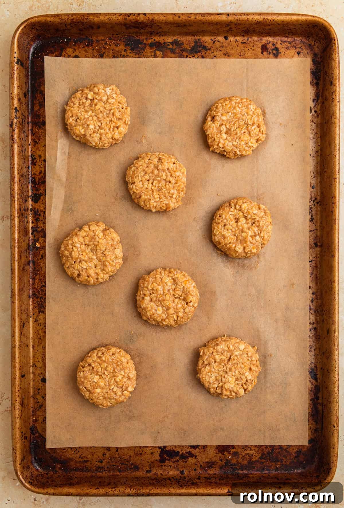 Morning Cinnamon Swirl Cookies 9 Scooped cinnamon roll oatmeal cookie dough balls arranged on a parchment-lined cookie sheet, ready for baking.