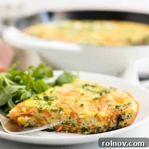 Sweet Potato Arugula Spiral Frittata 4 Close-up of a beautifully baked Spiralized Sweet Potato Frittata, garnished with fresh herbs, ready to be served.
