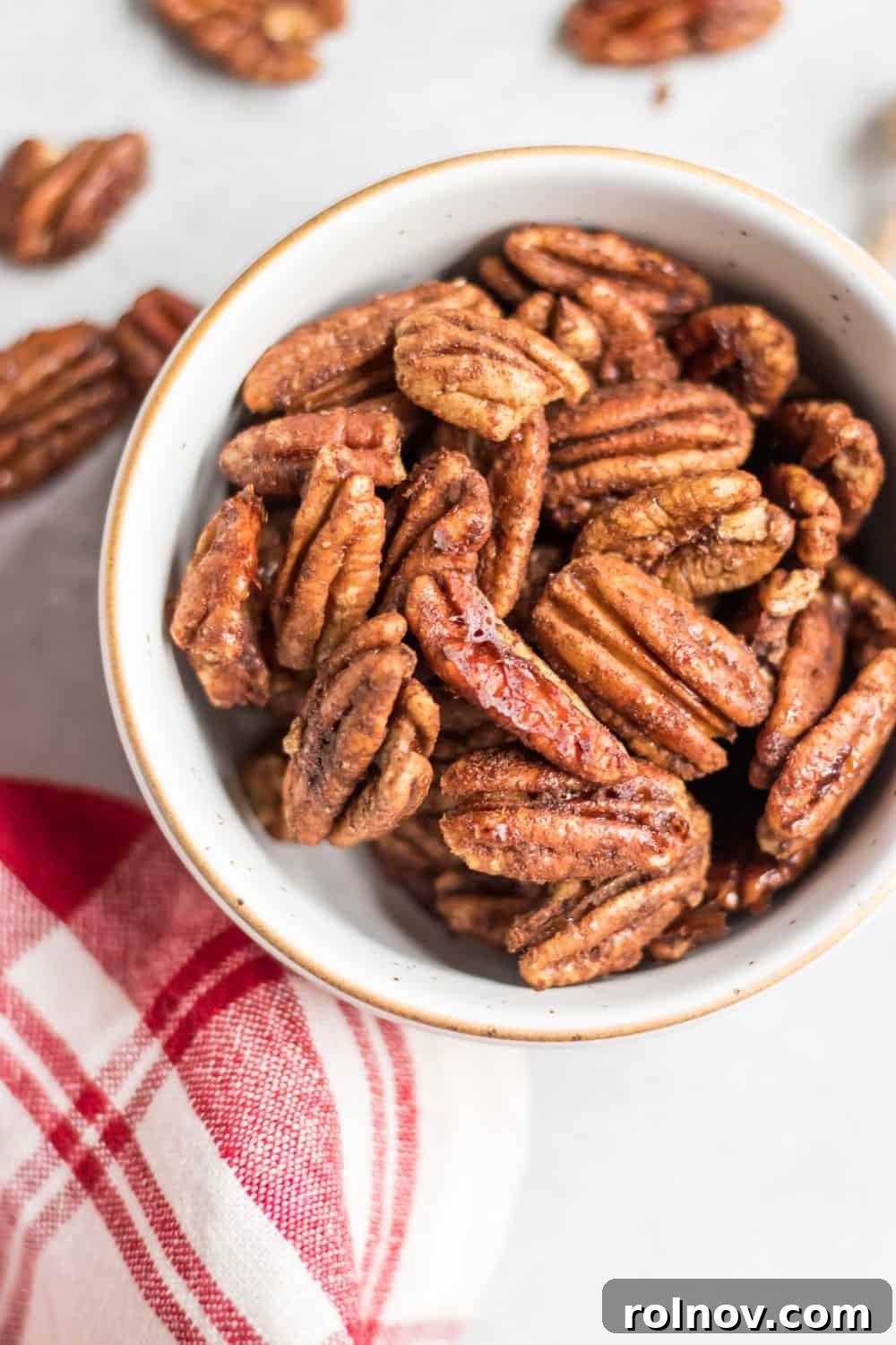 Maple Vanilla Candied Pecans 5 Maple Vanilla Spiced Pecans in white bowl with gold trim, ready to be enjoyed.