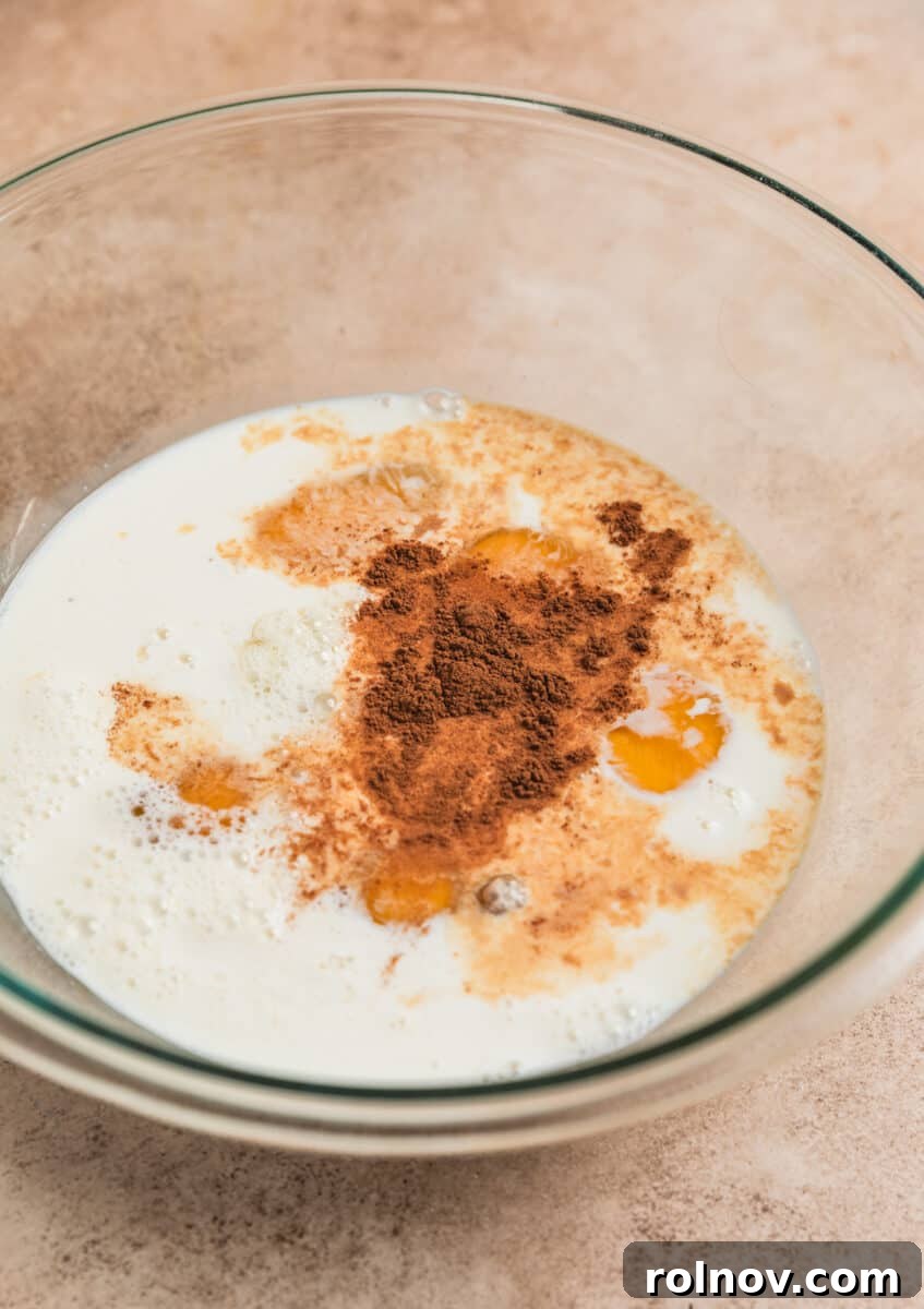 Golden French Toast Bites 5 Milk, cream, eggs, cinnamon and brown sugar in mixing bowl before whisking.
