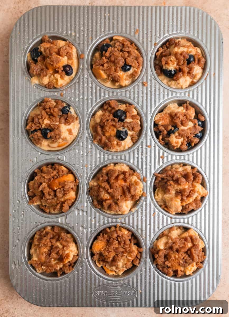 Golden French Toast Bites 9 Streusel topping on French toast muffins before baking.
