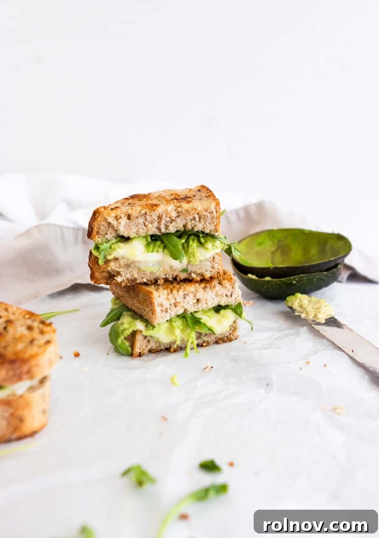 Decadent Havarti Grilled Cheese with Creamy Avocado and Peppery Arugula 5 A stack of golden-brown Havarti grilled cheese sandwiches, showcasing the crispy exterior.
