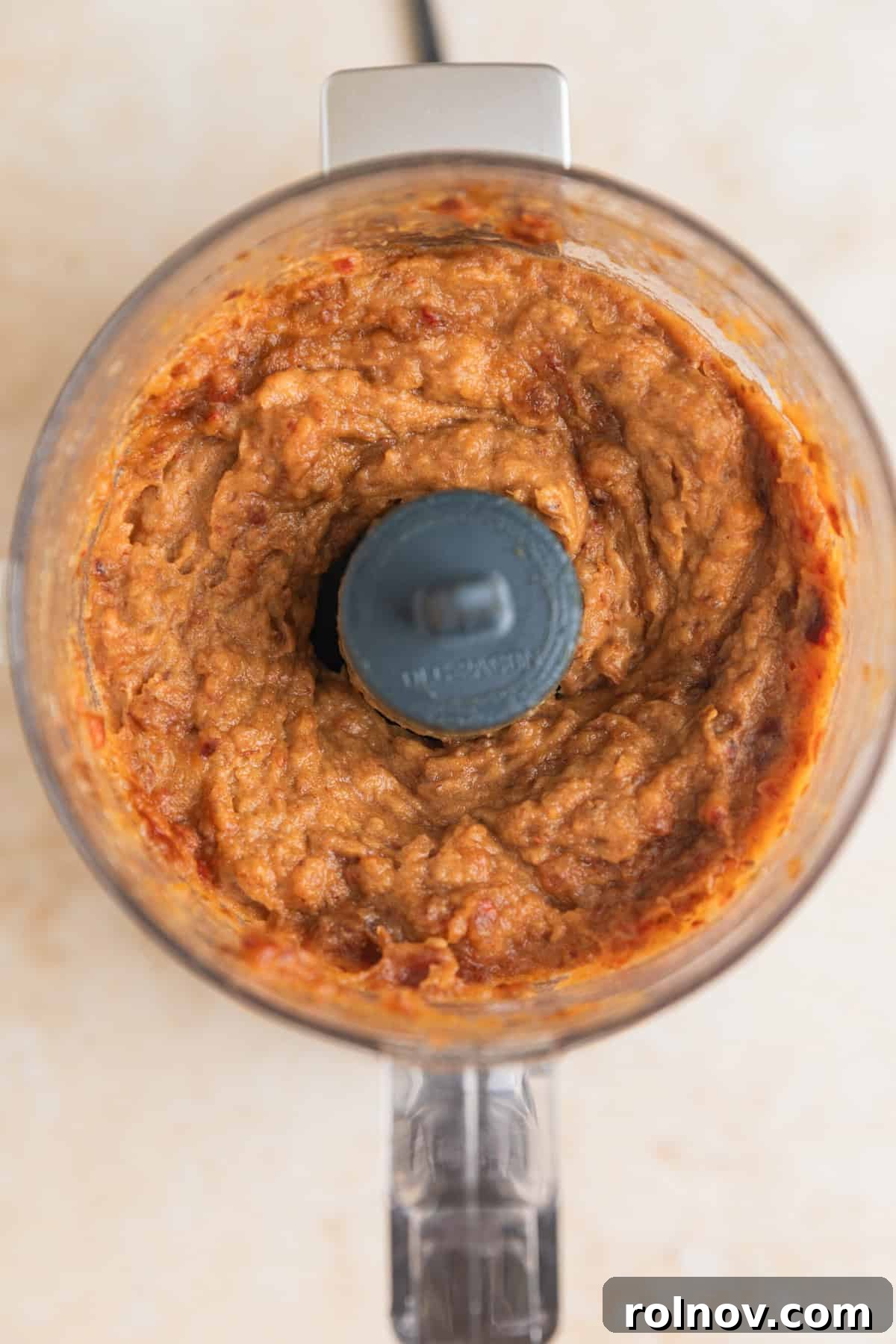 Adventure Fuel Bars 5 Pitted Medjool dates processed into a thick, sticky paste in a food processor.