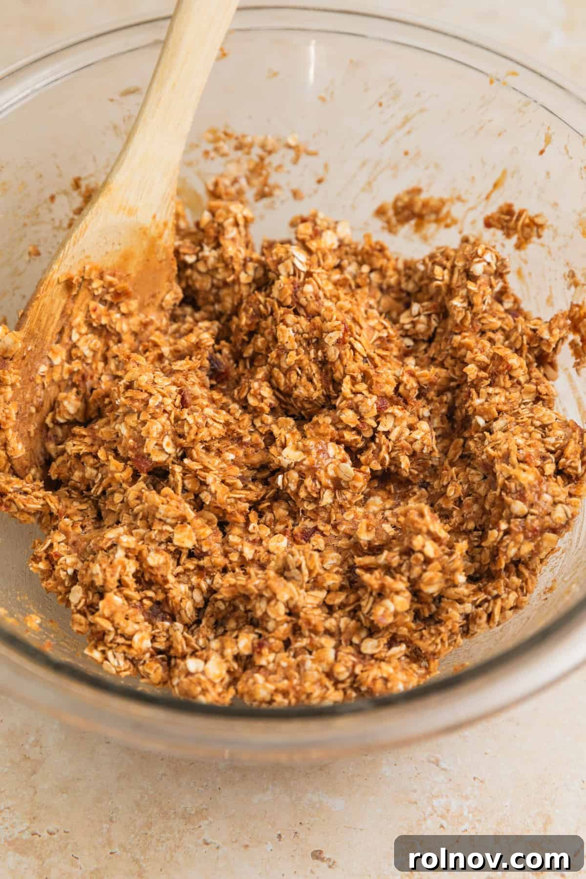 Adventure Fuel Bars 7 The peanut butter and oatmeal mixture after initial mixing, showing a thick, cohesive base.