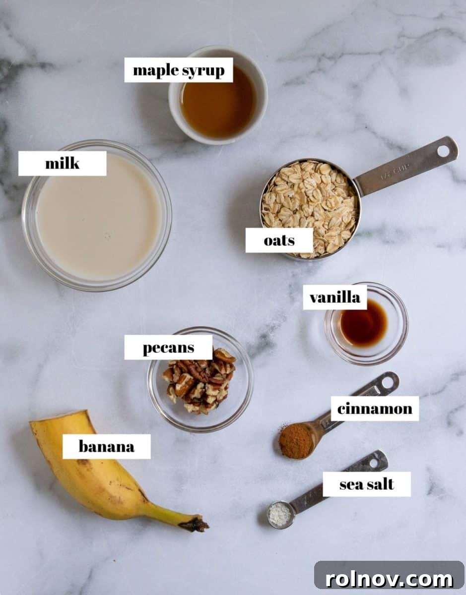 Individual ingredients for banana overnight oats laid out and labeled, including oats, milk, banana, and spices.