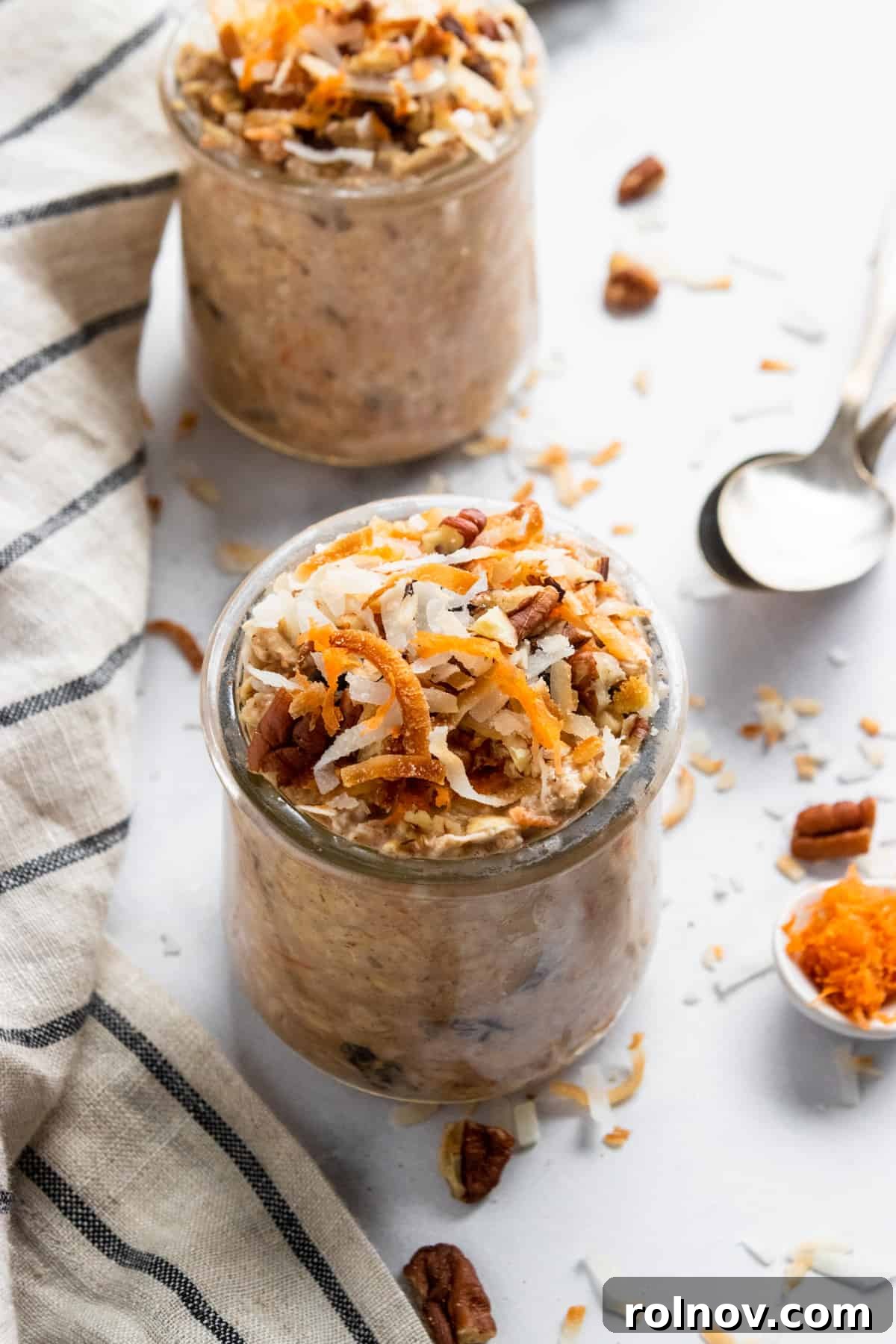 Spiced Carrot Cake Overnight Oats 3 Carrot Cake Overnight Oats in a glass jar, topped with extra shredded carrots and a sprinkle of cinnamon, ready to eat.
