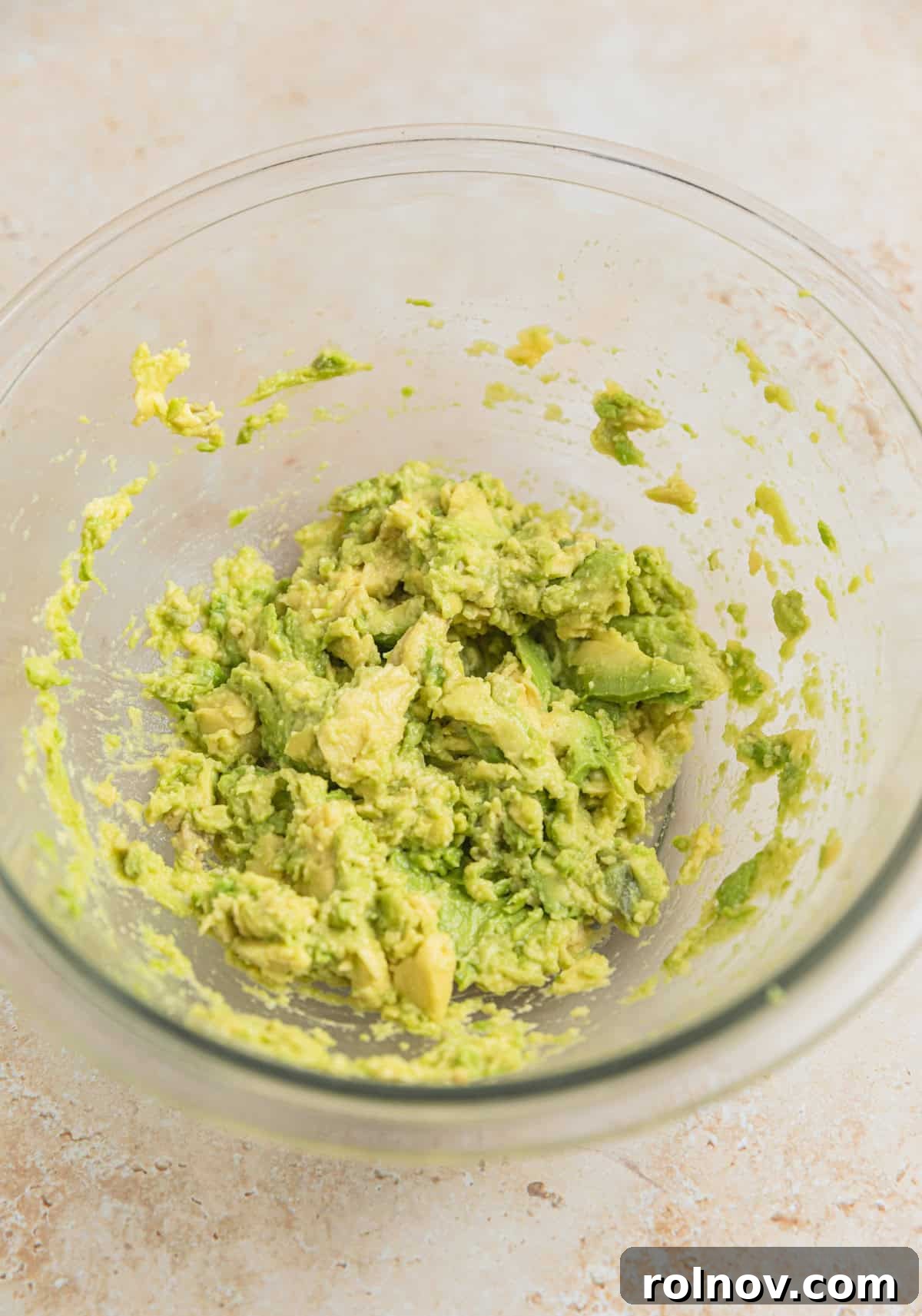 Creamy Avocado Ranch Tuna Salad 4 Glass mixing bowl with mashed avocado.
