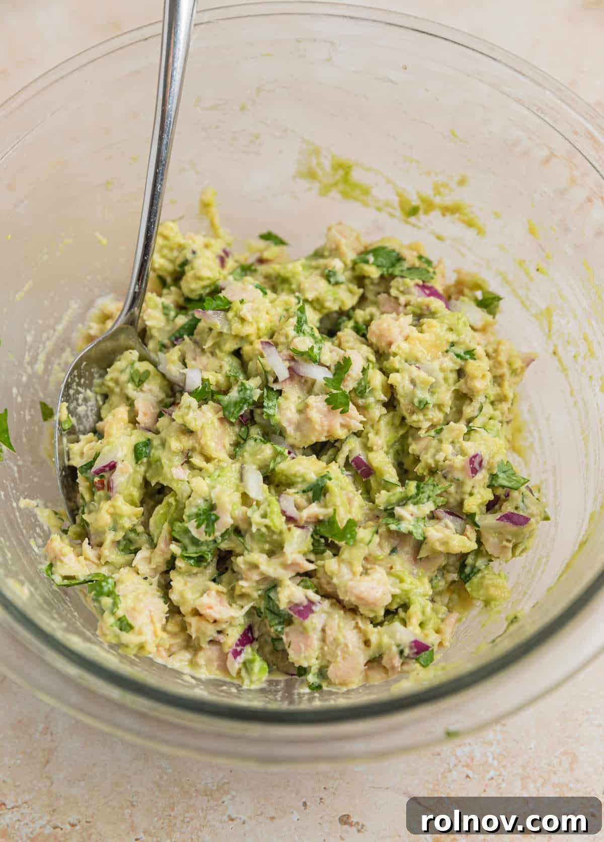 Creamy Avocado Ranch Tuna Salad 6 Avocado tuna salad mixed in bowl with spoon.