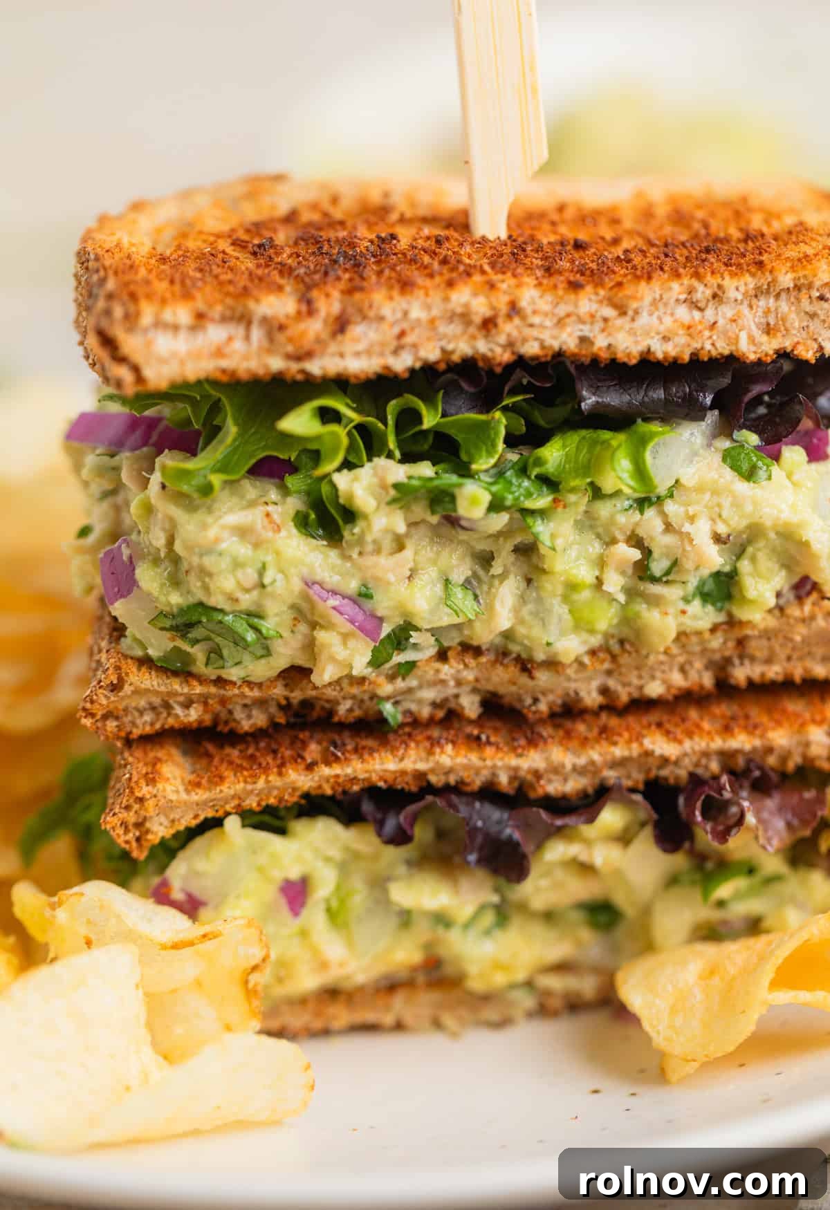 Creamy Avocado Ranch Tuna Salad 7 Tuna salad sandwich on plate with lettuce.
