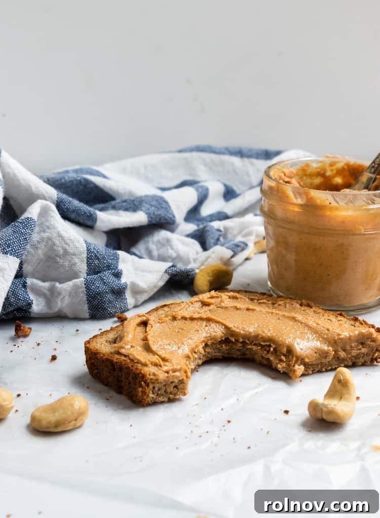 Silky Smooth Maple Vanilla Cashew Butter 4 Freshly roasted cashews cooling on a parchment-lined baking sheet, ready for processing.