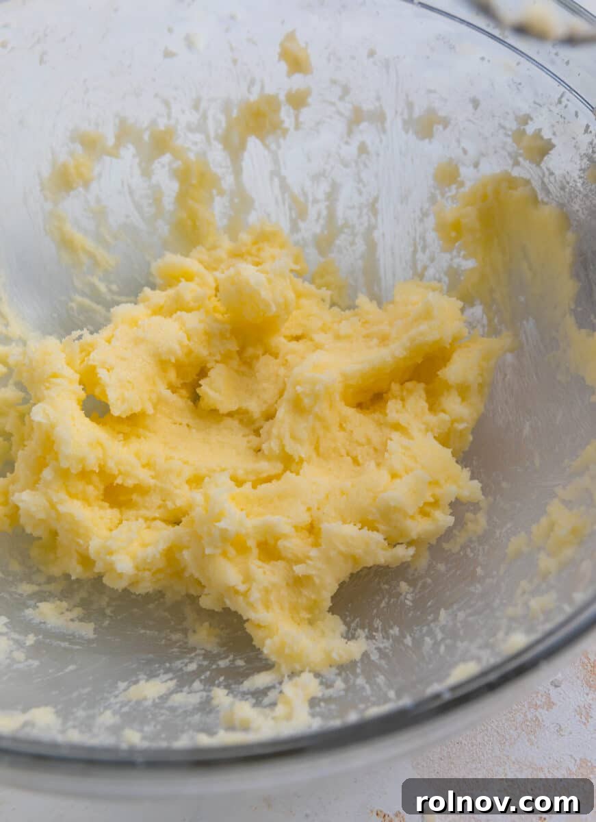 Spoonable Sugar Cookie Dough 3 Creamed butter and sugar in a clear glass bowl, showcasing its light and fluffy texture.