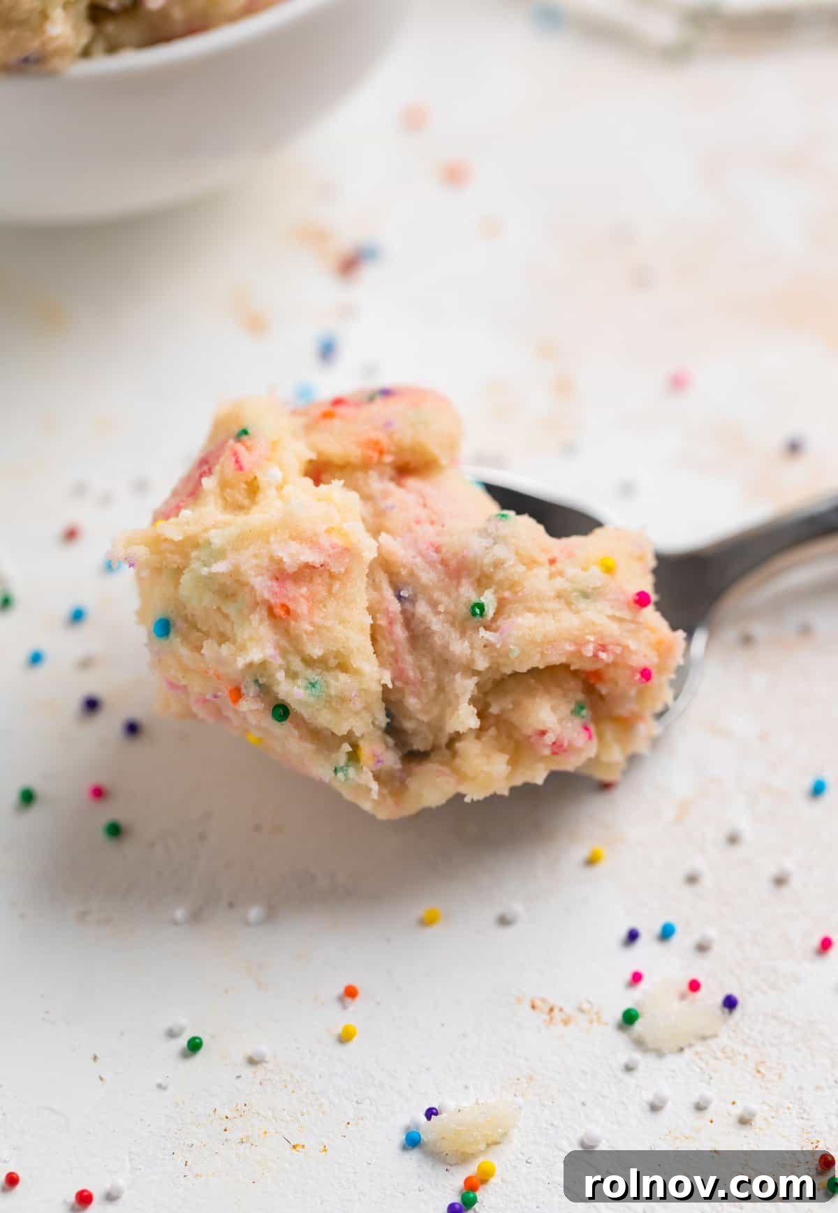 Spoonable Sugar Cookie Dough 7 A delicious spoonful of edible funfetti sugar cookie dough, bursting with color and ready to be savored.