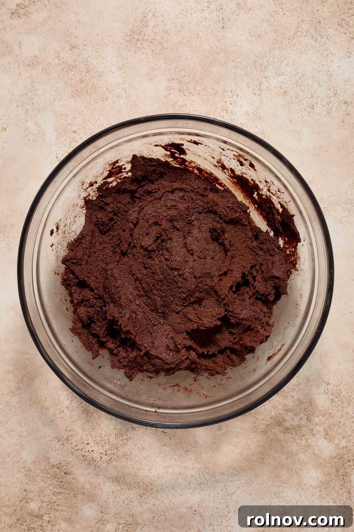 Chocolate lava cookie dough in a glass mixing bowl.