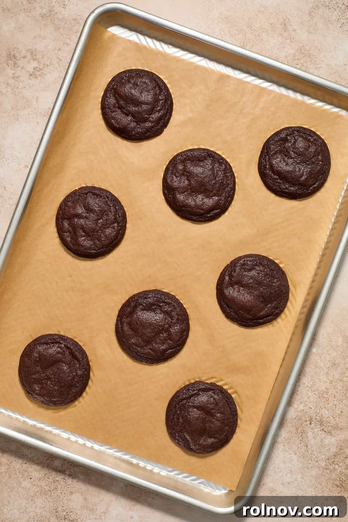 Freshly baked chocolate lava cookies on a cookie sheet.